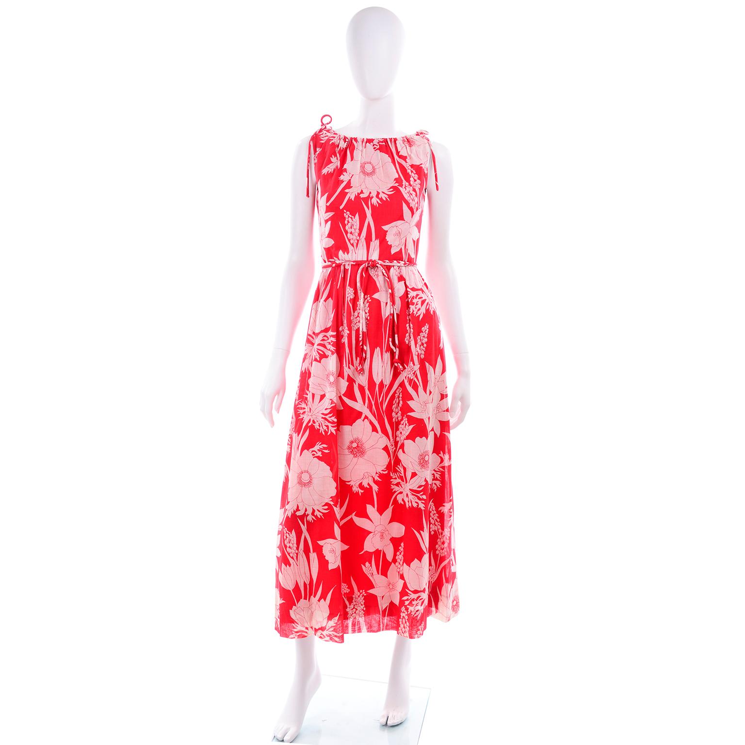 This bold red floral print vintage Adele Simpson sleeveless dress and cape ensemble was purchased at Harzfeld's Department Store in Kansas City in the 1970's. abel sewn in the bottom liner. This red and white floral printed cotton dress is lined in