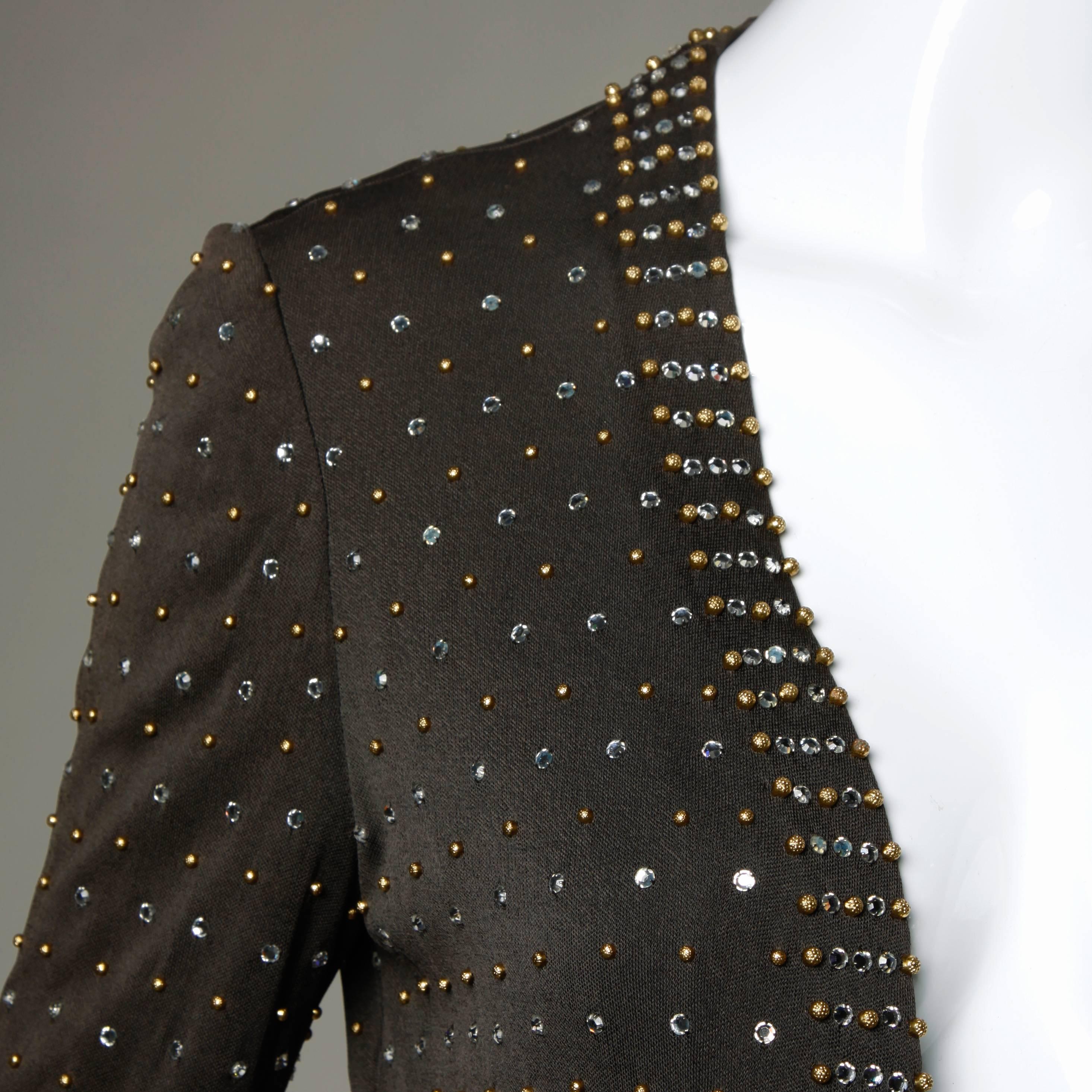 Stunning heavily beaded and rhinestone embellished silk jersey jacket by Adele Simpson. Heavy crystal rhinestones and hand beadwork!

Details:

Fully Lined
Marked Size: Not Marked
Estimated Size: S-M
Color: Dark Taupe/ Gold/ Crystal 
Fabric: Silk