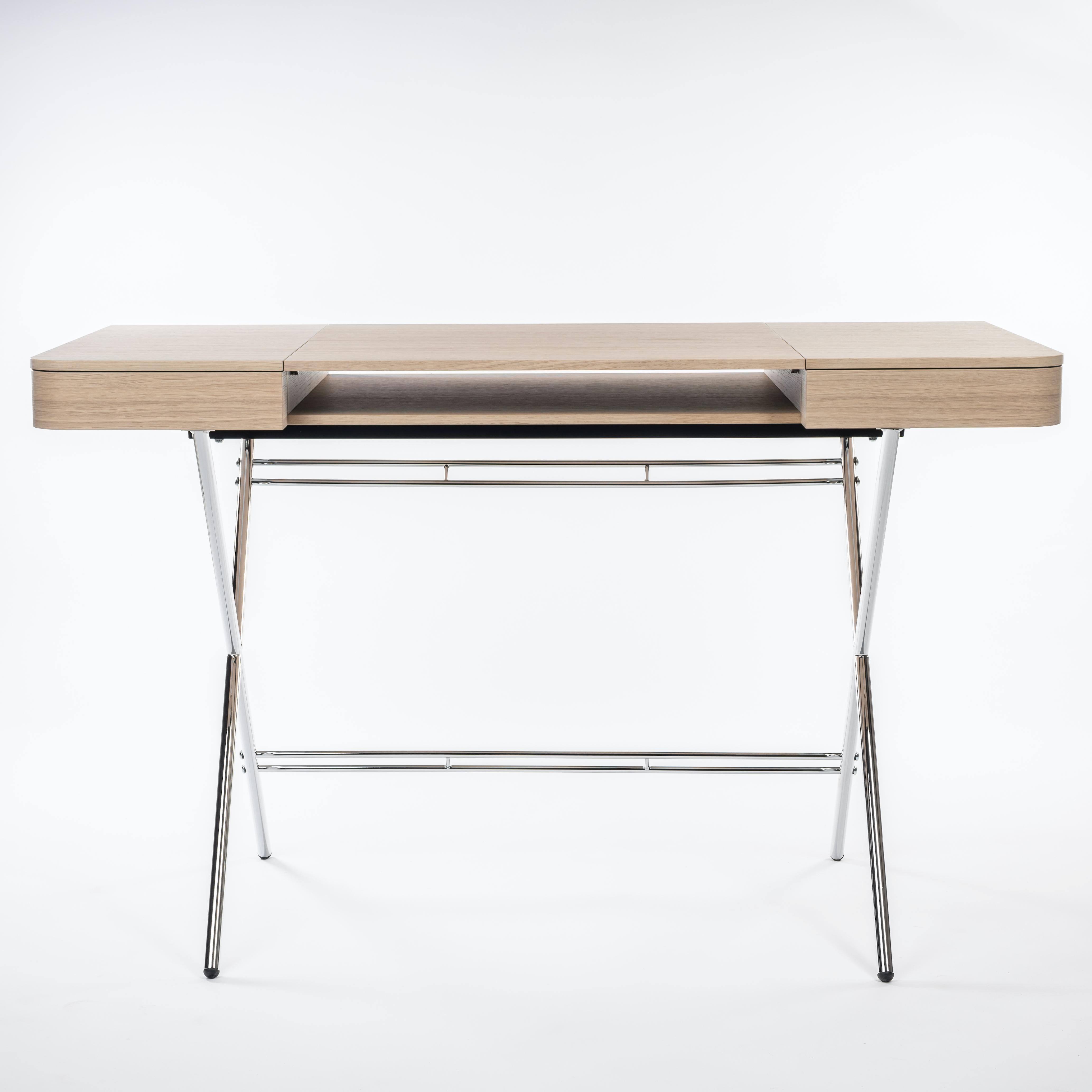 The Cosimo desk was designed by the architect Marco Zanuso Jr. in 2017 for luxury French furniture brand, Adentro Paris. The central panel of the desktop folds back to reveal a hidden shelf below, and integrated drawers on either side provide ample