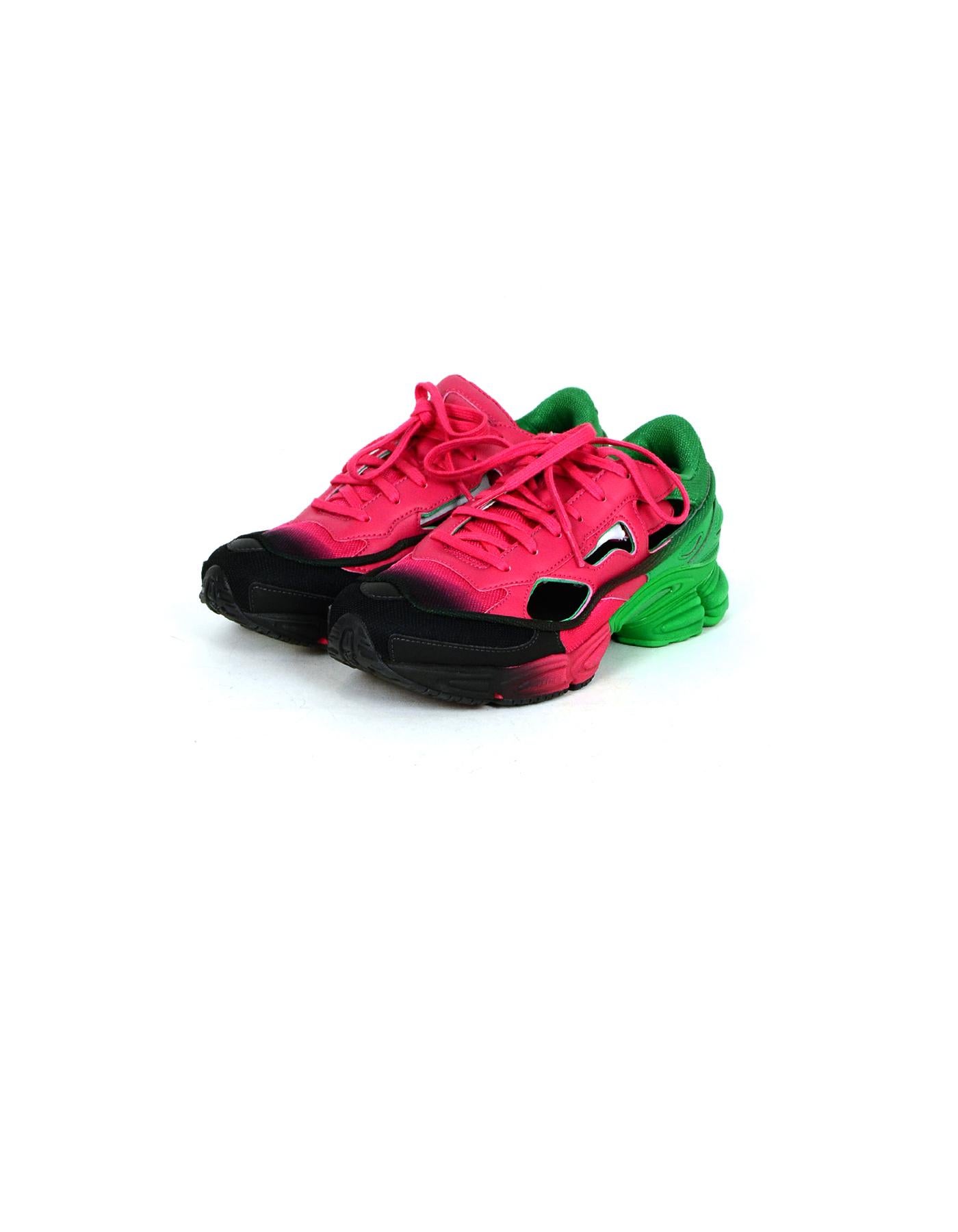 Adidas by Raf Simons Pink/Green/Black Ozweego Replicant Cut Out Sneakers

Made In: China
Color: Pink, Green, Black
Materials: Leather, Fabric
Closure/Opening: Lace-up
Overall Condition: Excellent pre-owned condition, with the exception of minor wear