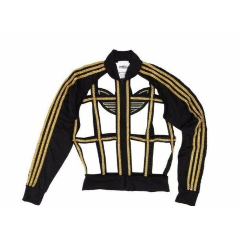 Adidas Originals Jeremy Scott JS Chain Cage Jacket Rare Unisex *Britney Spears*

Additional Information:
Material: 100% Polyester
Color: Black / Gold  
Pattern: Chain Cage
Style: Tracksuit Jacket - Casual    
Size: M
100% Authentic!!!
Condition: