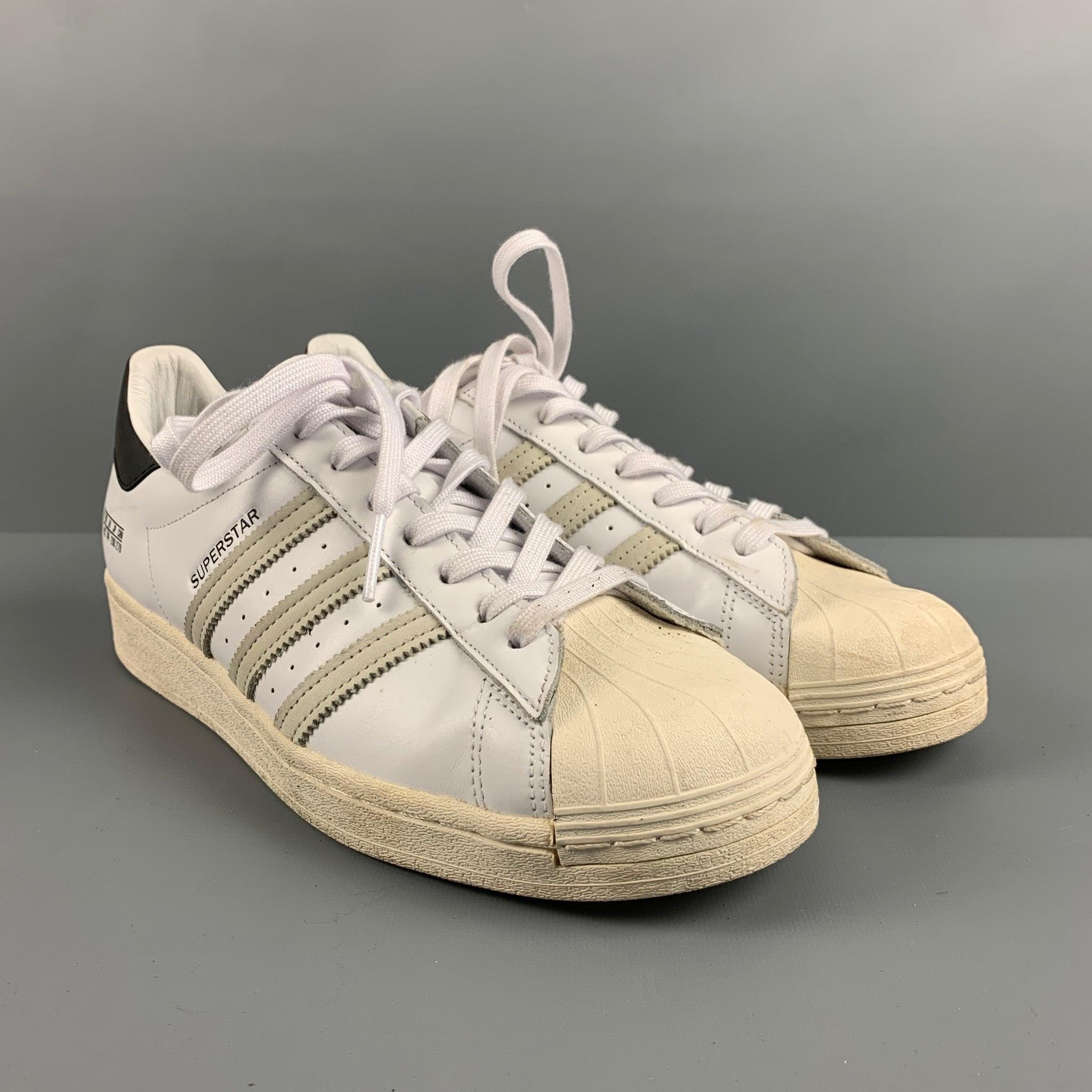 ADIDAS Superstar sneakers come in white leather with beige suede panels, beige rubber sole and toe cap. Very Good Pre-Owned Condition. Minor signs of Wear. 

Marked:   10Outsole: 11.75 x 4 inches  
  
  
 
Reference: 127376
Category: Sneakers
More