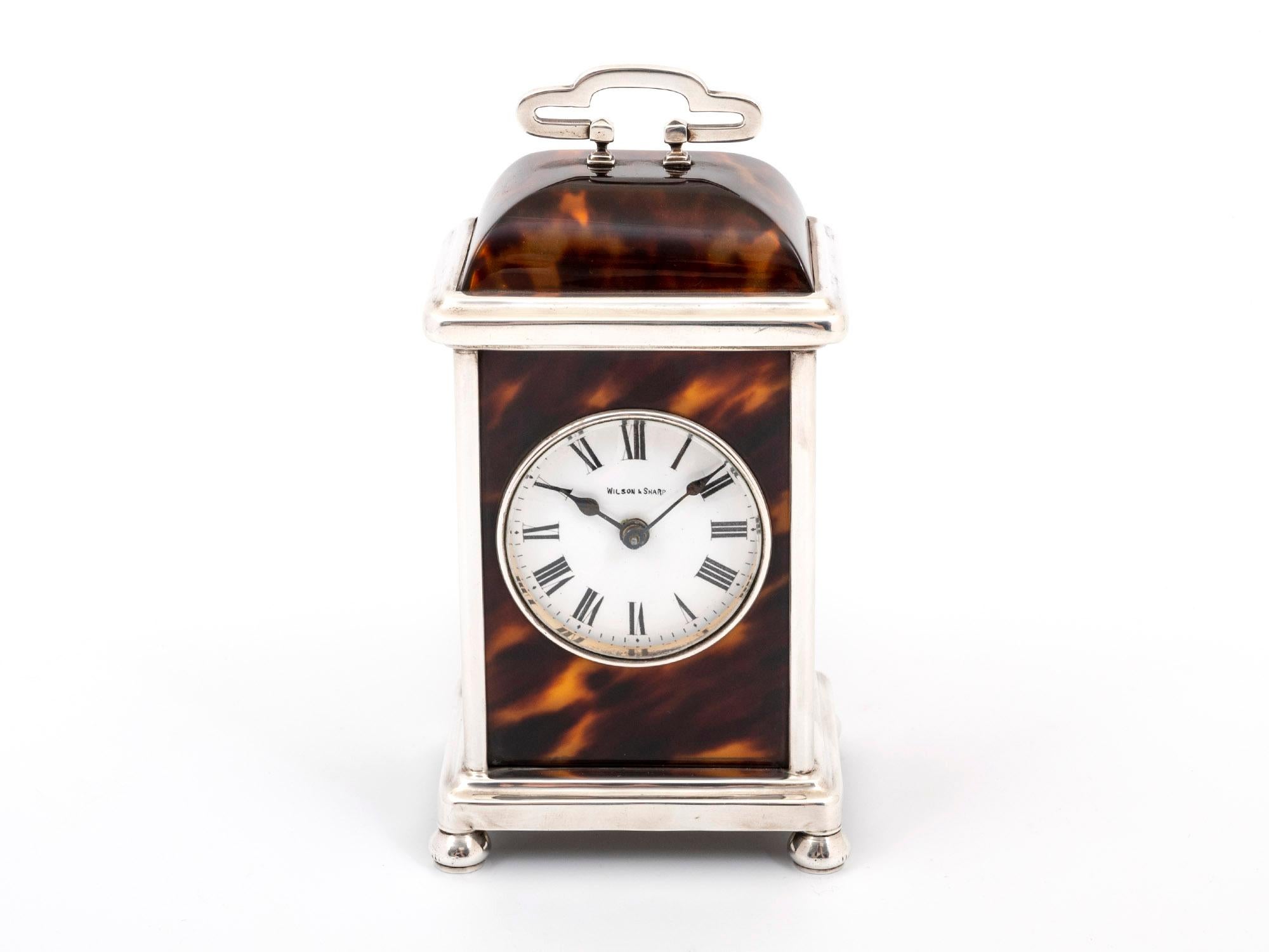 This is a charming little tortoiseshell and sterling silver carriage clock by Birmingham Silversmiths, Adie Brothers.

This Sterling Silver Carriage Clock has beautifully figured Tortoiseshell panels. Featuring a wonderfully classic dome-shaped