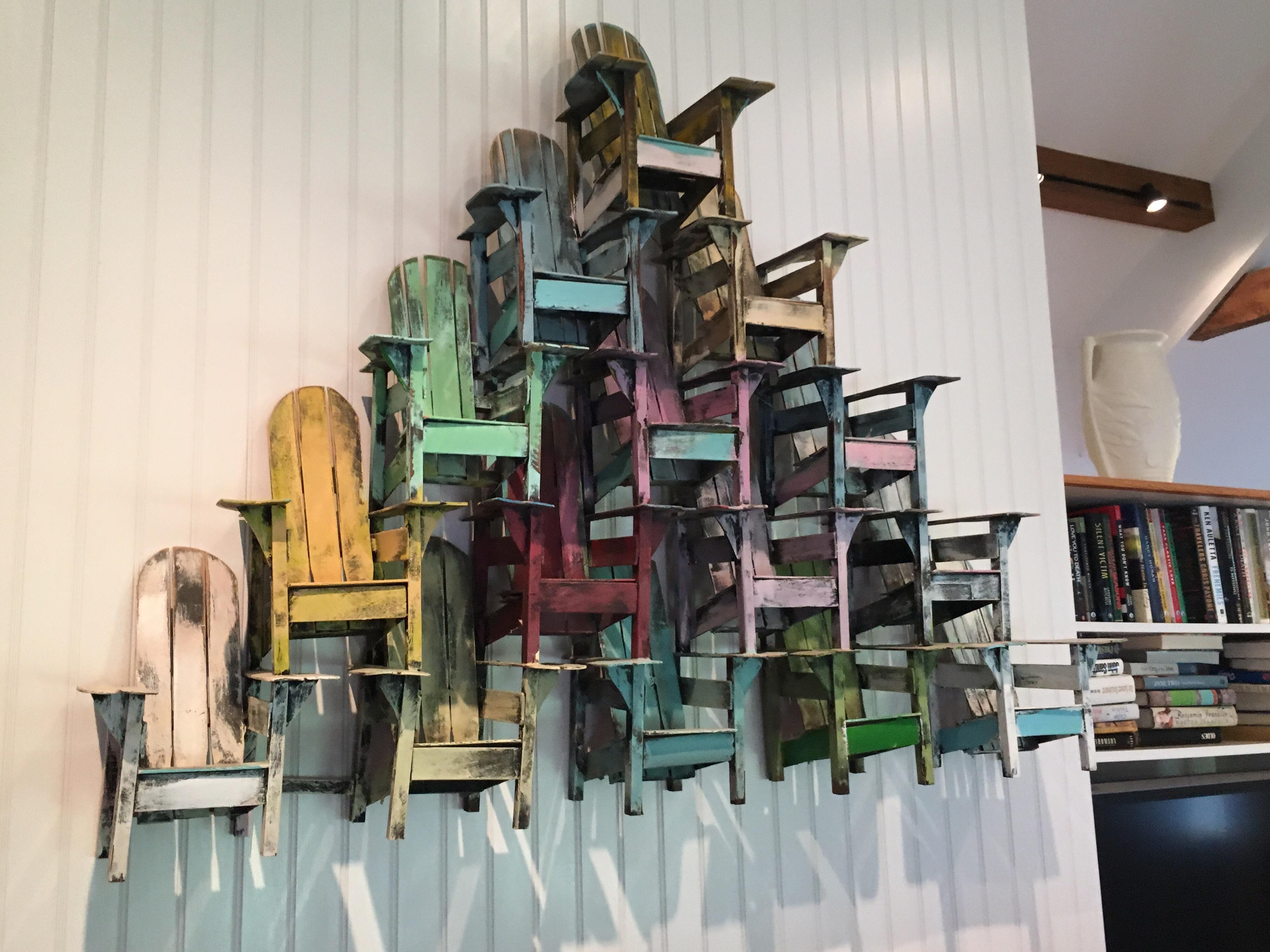 Paul Jacobsen, American, (1943-2018)
Fifteen Adirondack chairs stacked, neatly, in a pyramid formation and painted in bright colors. All made by hand by Jacobsen. Signed, 9/92,
Acrylic on wood, unique pyramid shape. 

Among his most famous works are