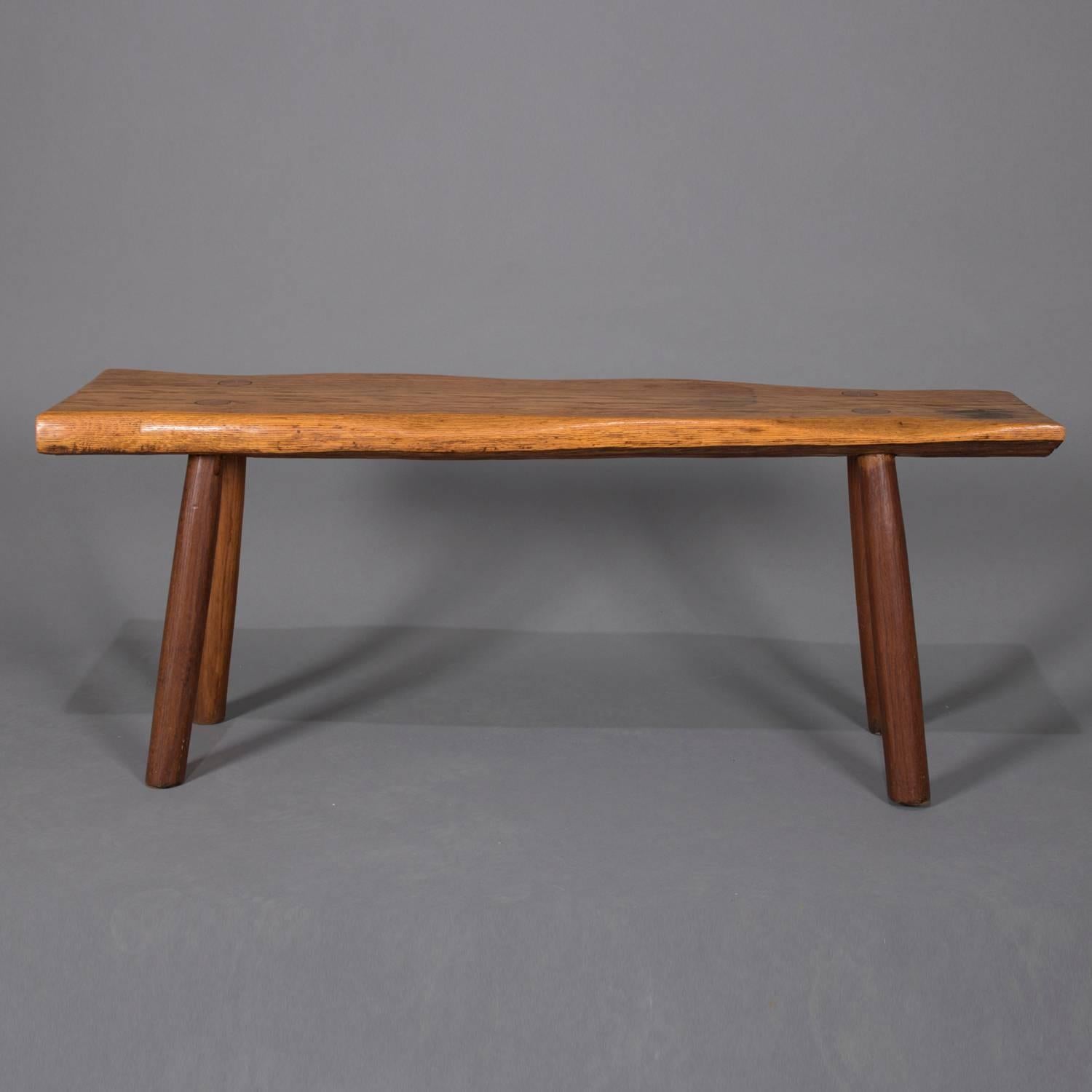 Adirondack Old hickory school hand-carved bench features slab wood seat with mortise and tenon legs, circa 1940.

Measures: 19.5
