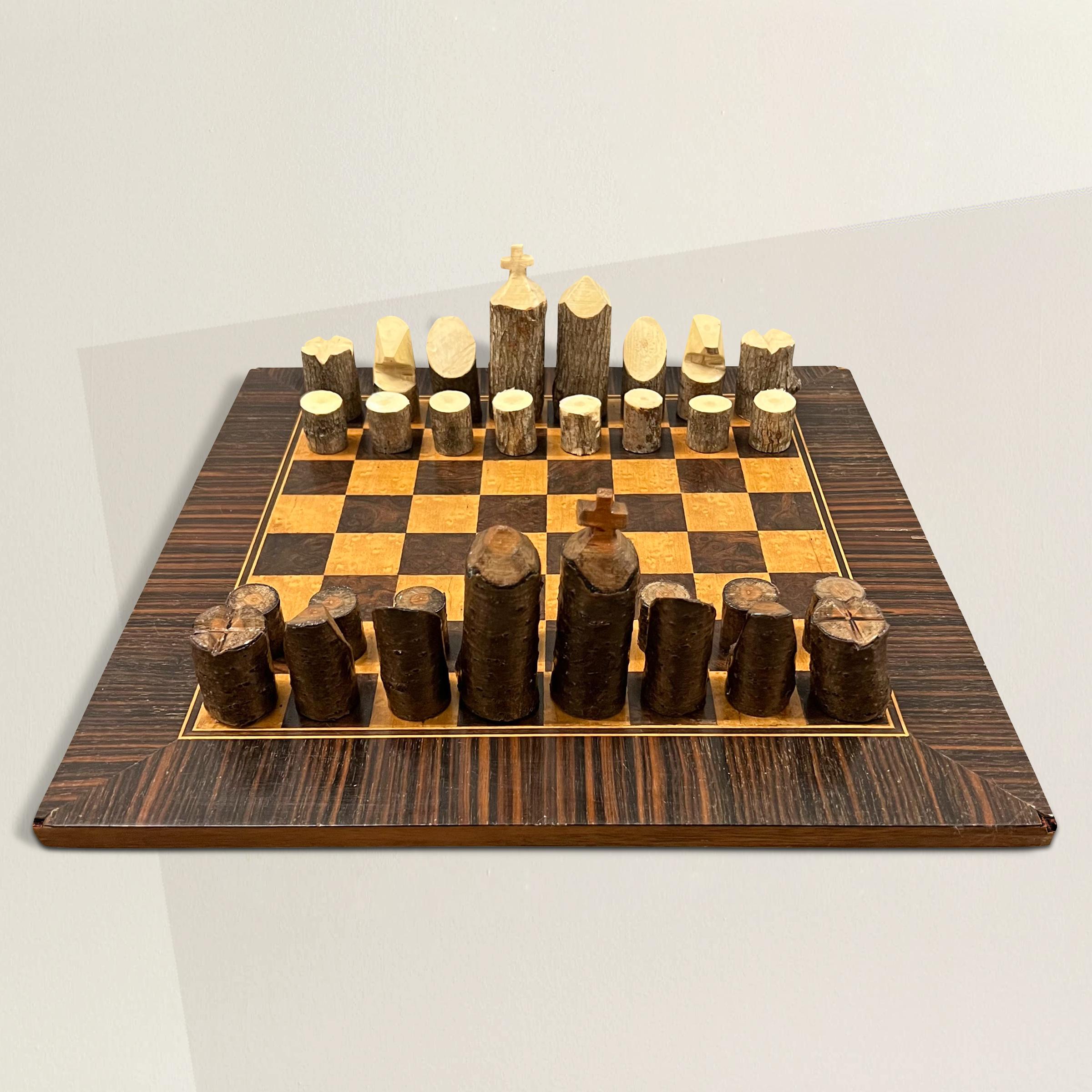 A playful 20th century American Adirondack-style chess set with a board with burl, ebony, and maple inlay, and rustic hand-carved cherry and ash pieces. The perfect set for your cabin or country house.