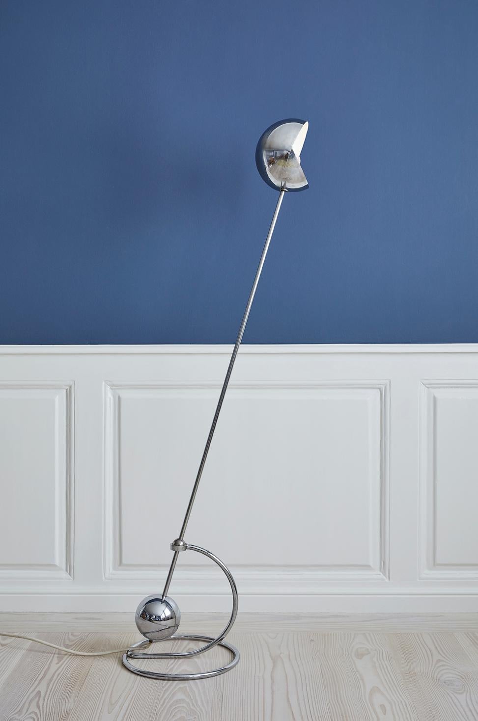 A rare adjustable 3S floor lamp designed by Paolo Tilche in 1972, produced by Sirrah, Bologna. 

The large, chrome-plated metal counter weight keeps the long arm perfectly balanced in the tubular base. The two hemispherical shades on the other end