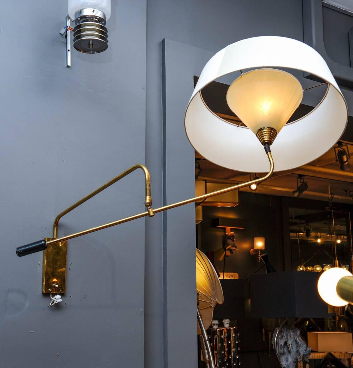 Cool wall sconces made of two adjustable arms in brass, handle in black enameled metal and an original double lampshade. Power switch on the base.