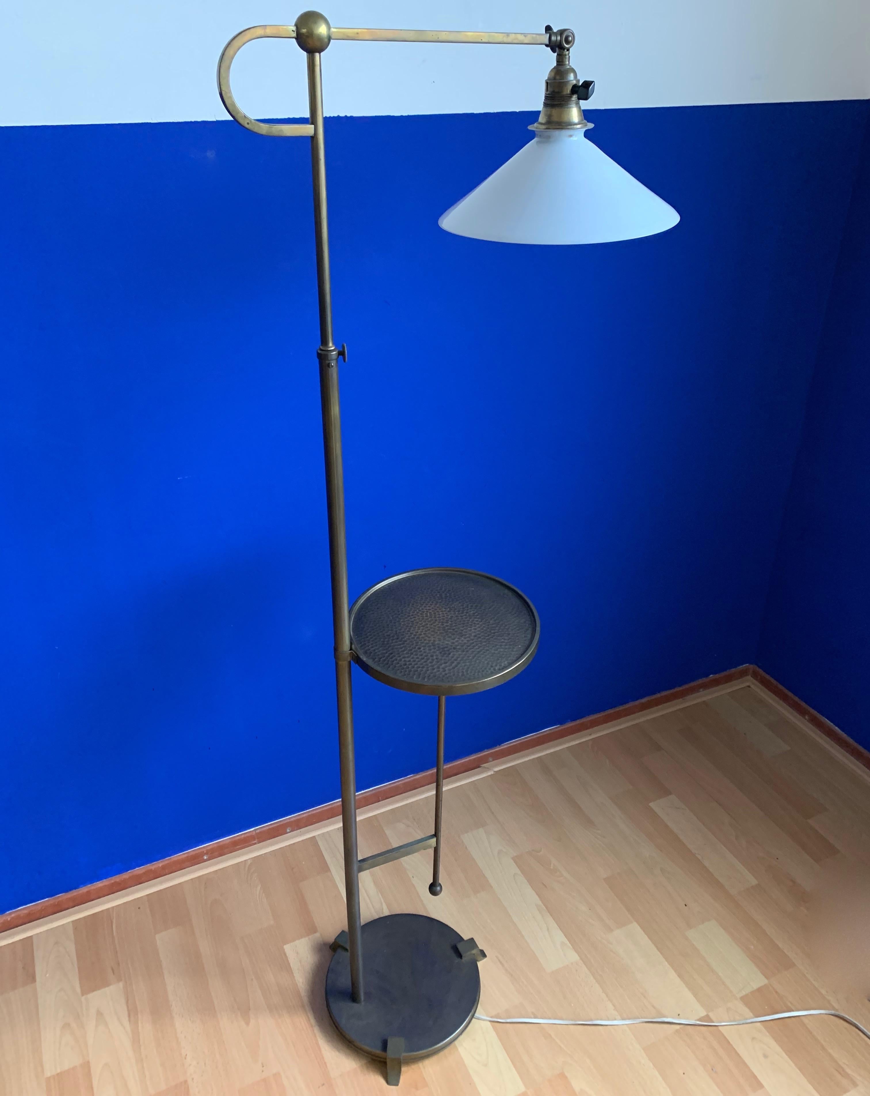 Adjustable 1920s floor lamp in Viennese Style.

This beautiful quality and great condition floor lamp from the early 20th century is a real joy to own and look at. The opaline shade can be placed in different angles and the brass stem is easy to