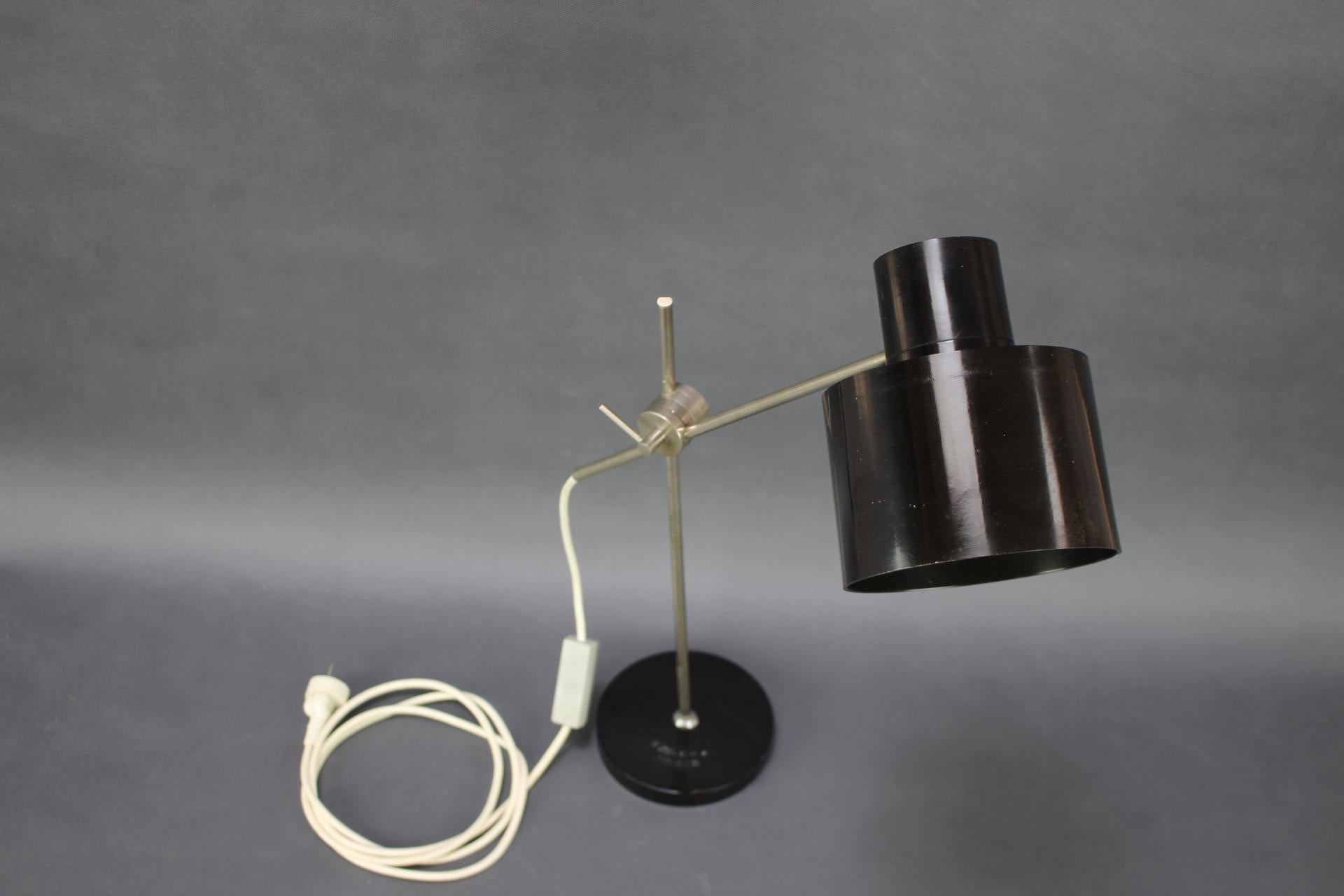 - Adjustable Black Bakelite Industrial Table Lamp / Czechoslovakia, 1970s,
- made of Metal and Bakelitte,
- in highest dimension 90cm,
- shows signs of wear and age (scratches, etc.),
- In original good condition