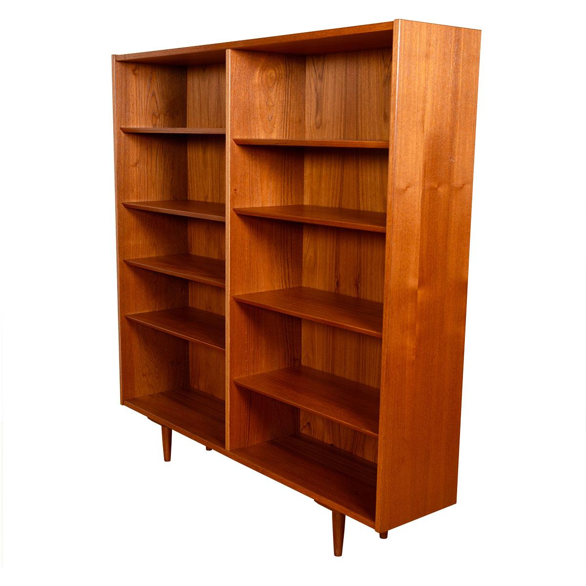 Stunning Danish Modern bookcase. Fabricated of walnut, the graining and tones of the wood make a gorgeous backdrop to any display. The double bookcase has adjustable beveled shelves throughout. The overall styling is straightforward putting the