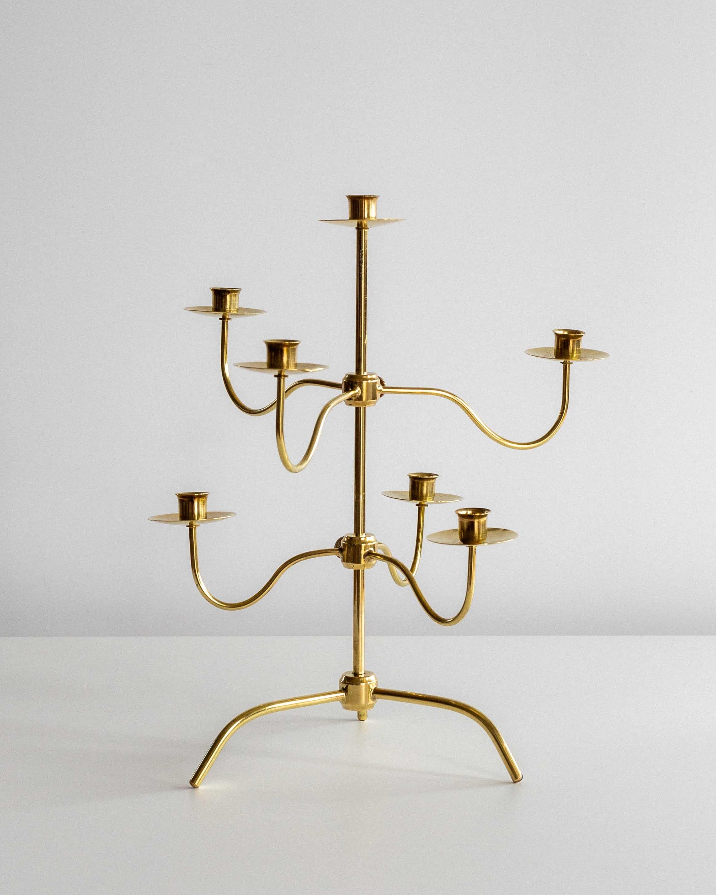 A rare and elegant brass candelabra from the 1950s, attributed to renowned designer Josef Frank for Svenskt Tenn, the iconic Stockholm-based interior design company established in 1924. 

This beautifully crafted brass centerpiece holds seven