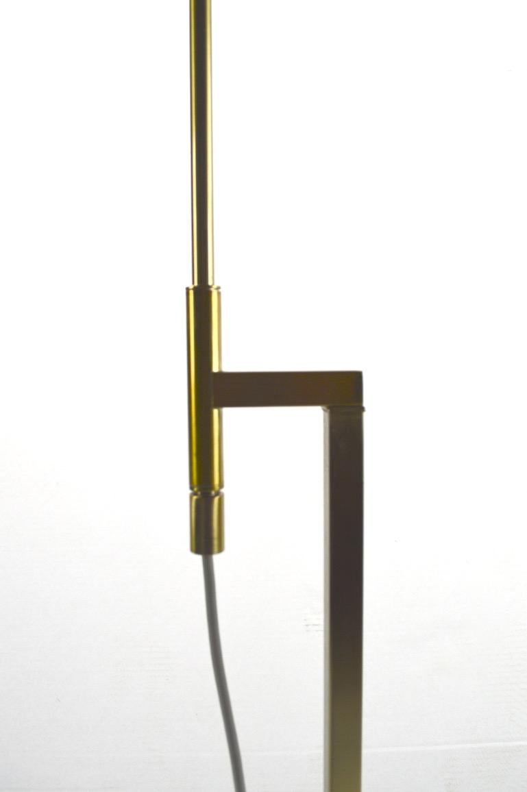 Extra clean and nice example of the Classic adjustable Laurel floor lamp. Squared brass construction in original satin finish. The vertical tubular arm raises and lowers to position lamp - lamp in highest position 66 inches H x 43.5m inch in lowest