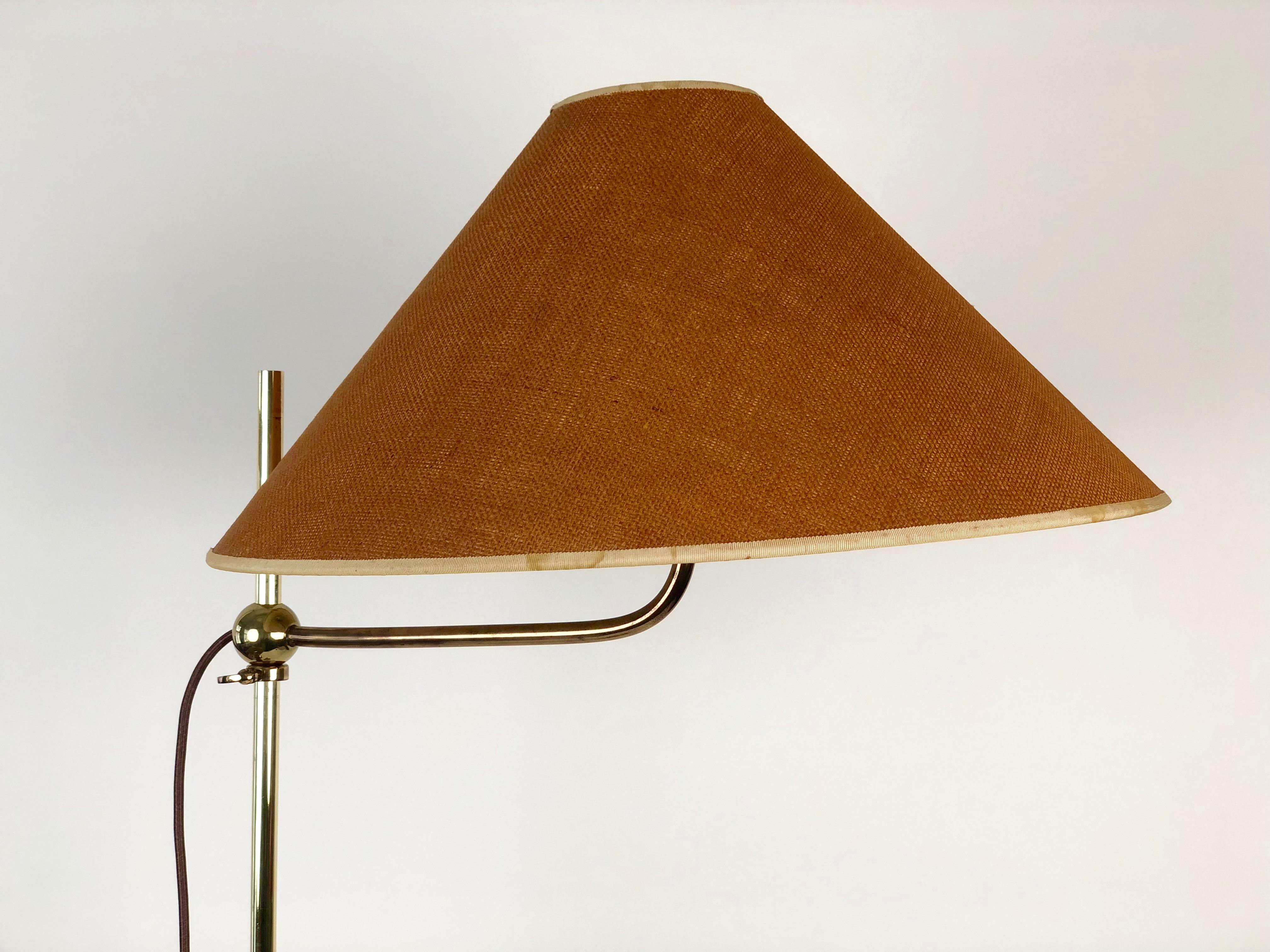 This beautifully made brass lamp, from the 1960 s is fully adjustable in height and rotation of the arm. The simplicity of adjusting the height by using a sliding ball with a locking is wonderfully executed. The arm can rotate 360 degrees without