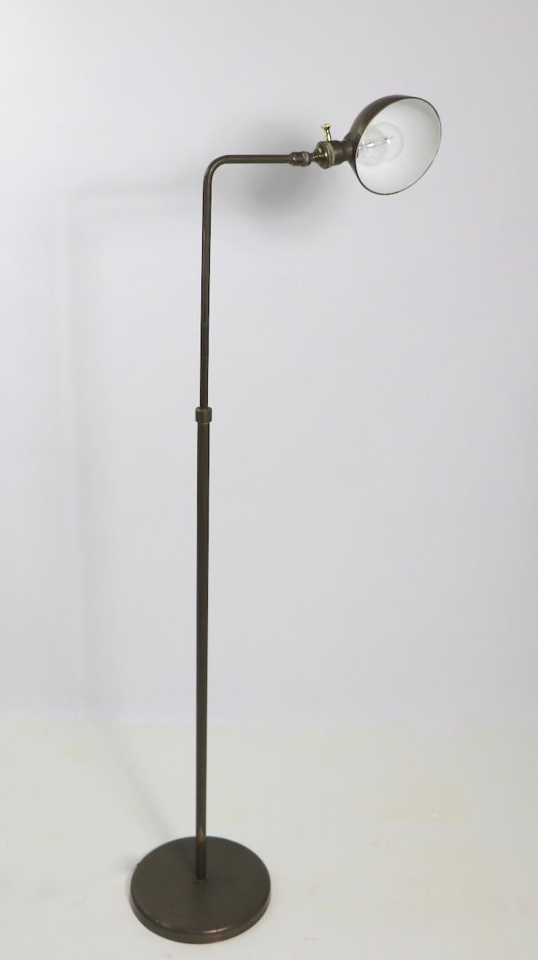 Adjustable brass floor lamp having a dome shade ( 6 in. Dia. ) which tilts to direct the light, attached to an arm which swivels, and a vertical center post which raises and lowers ( 37 - 50 in ). Base 10 in. On/Off ( dimmer ) switch is new.