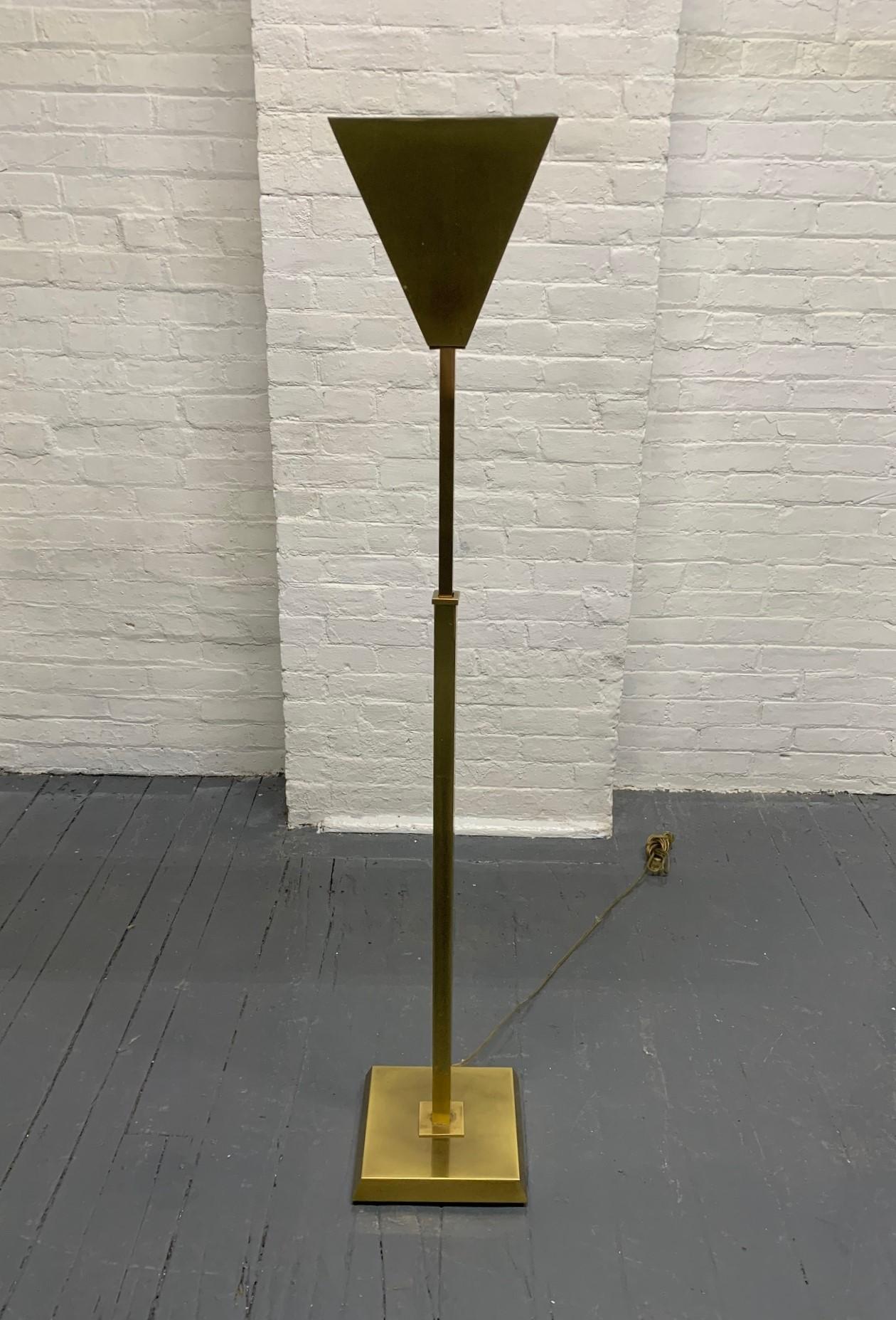 Adjustable brass torchère lamp by Nessen.
Ranges in height from 52