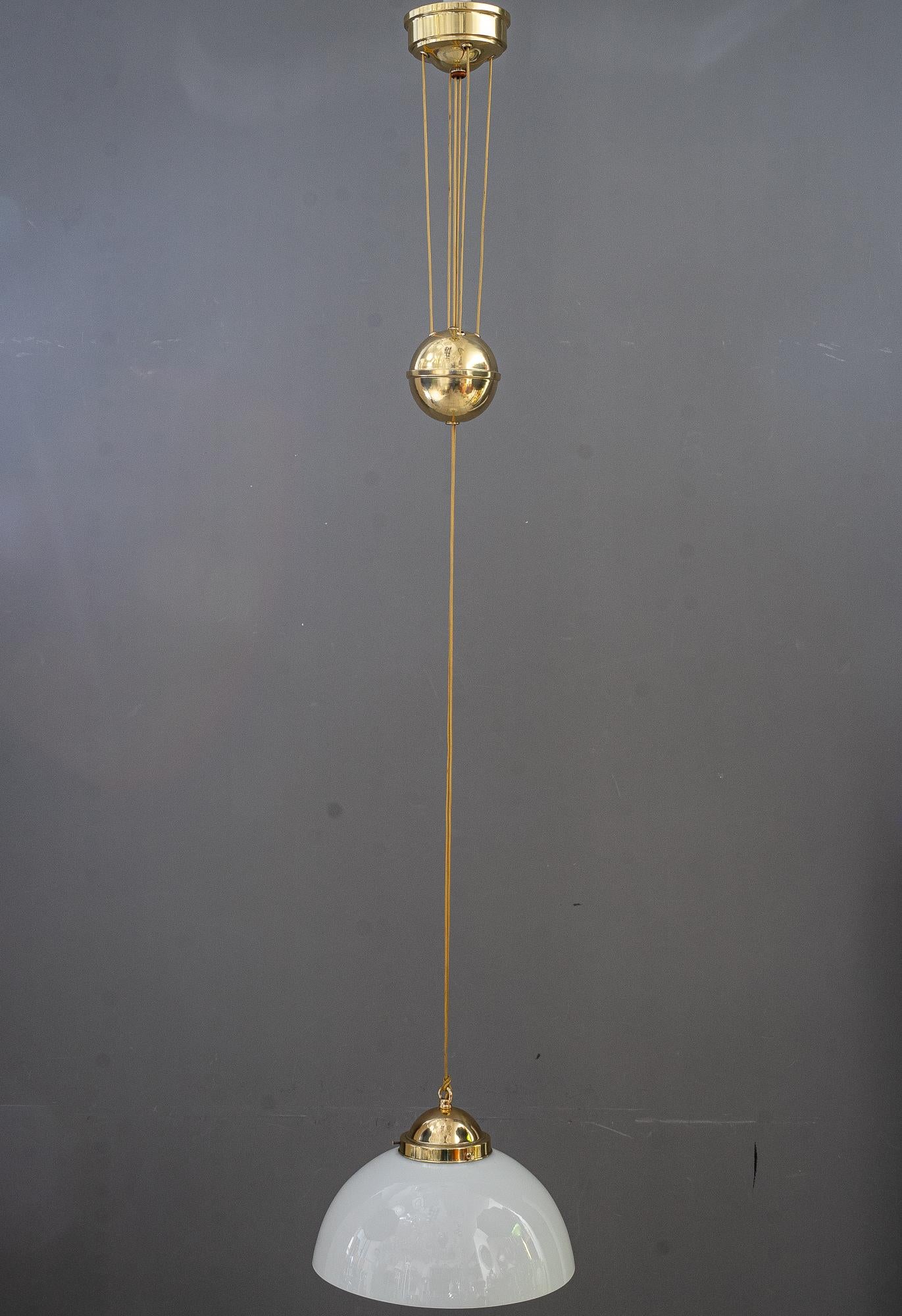 The height is adjustable from 94cm up to 180cm
Brass polished and stove enameled
Original old opal glass shade