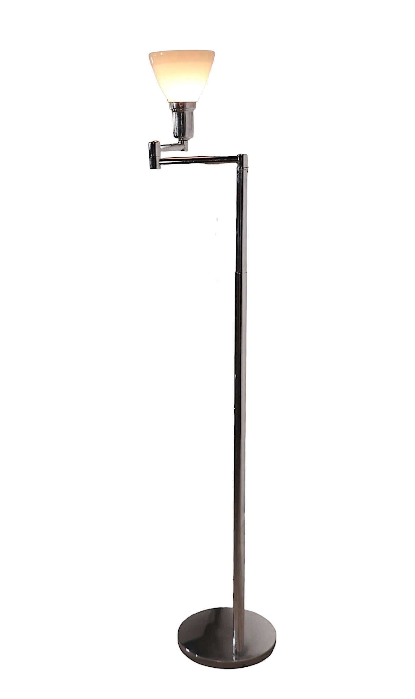 Iconic modernist flex arm floor lamp, designed by Walter Von Nessen, produced by Nessen Studios.  The lamp features a jointed two part arm which supports the socket, and glass diffuser. The vertical standard ( center pole ) is extendable to raise