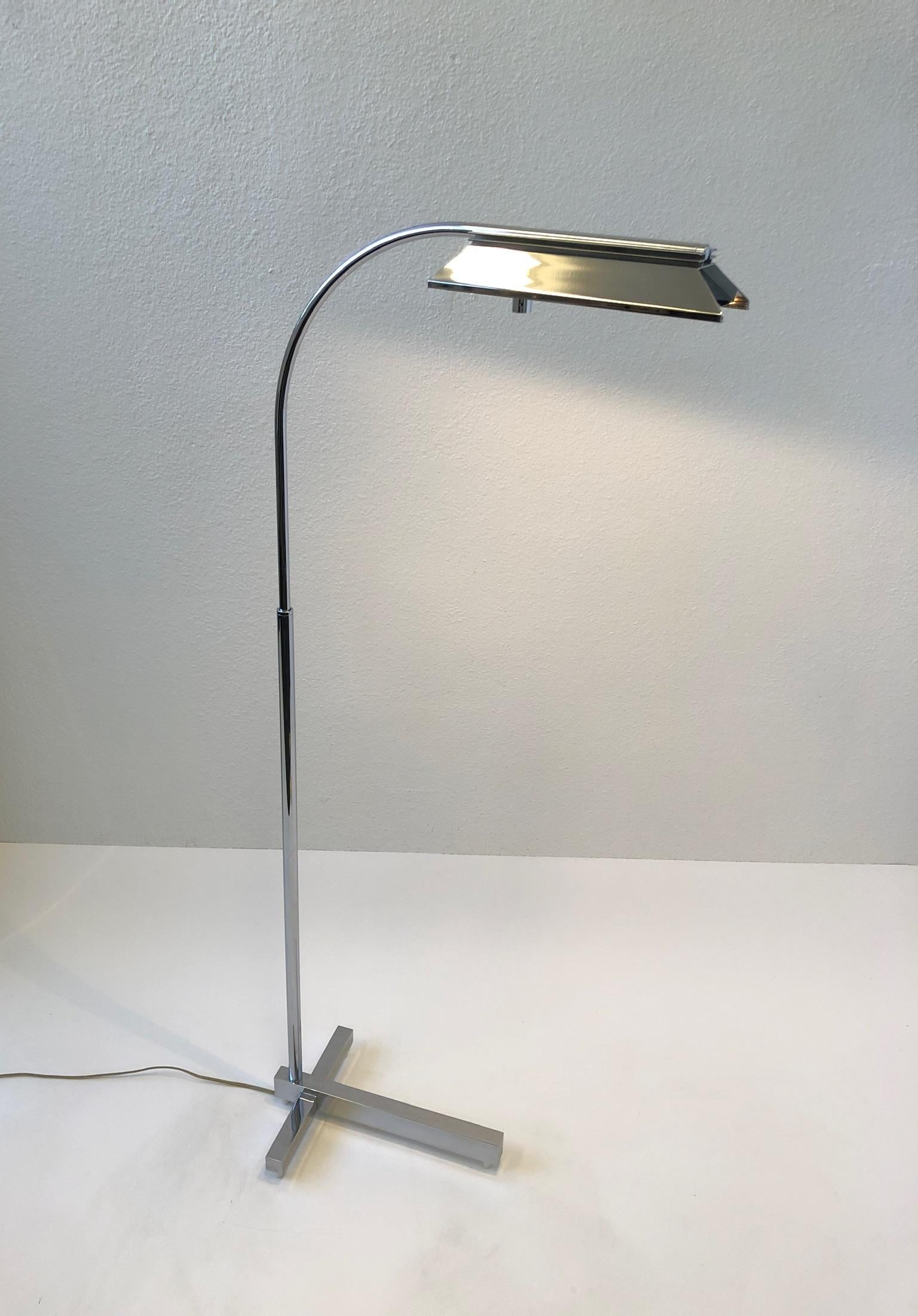 1970’s adjustable polish chrome floor lamp design by Casella. 
Can be rotated 360* and can be lower down to 39.25”or extend up to 54.25” high. 
It has a full range dimmer built in the shade.