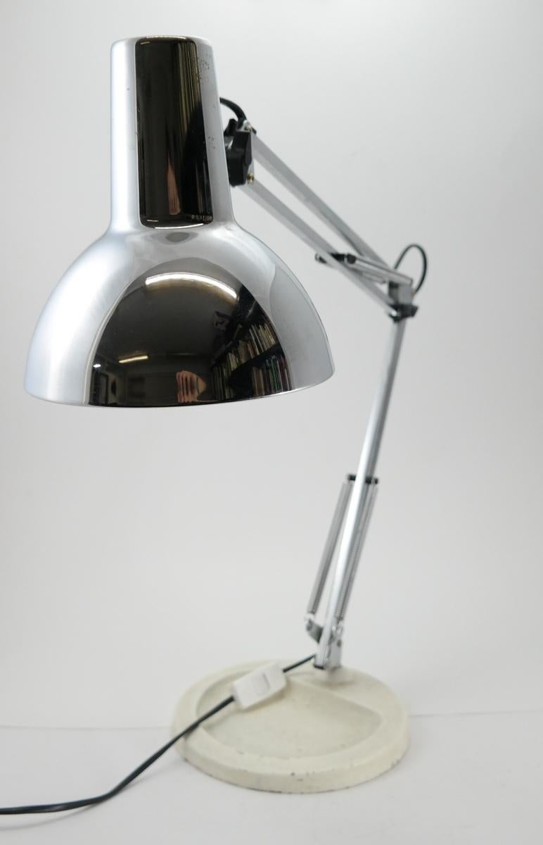 Adjustable chrome table lamp with cast iron base.