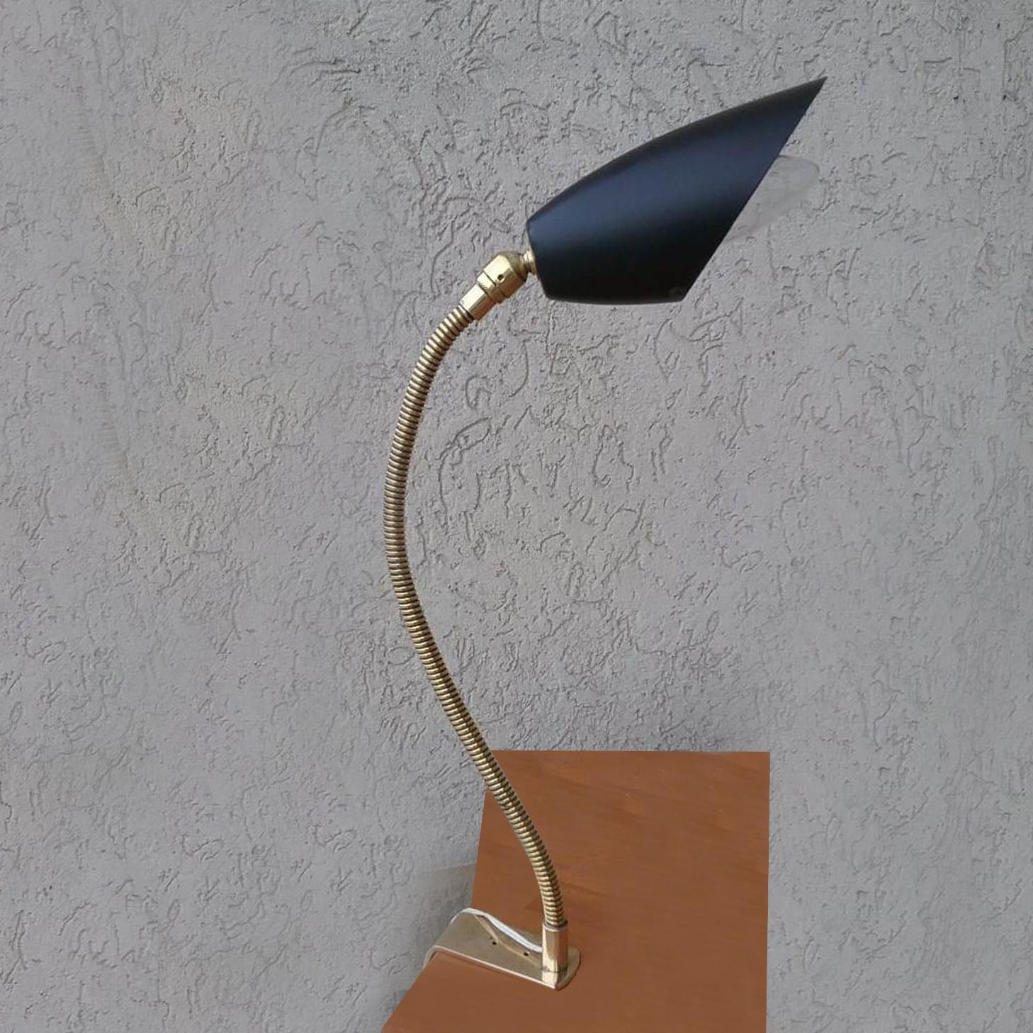 This table light is composed of an black painted aluminum lamp shade and flexible high polished brass gooseneck pipe rod.
Pole attached to base can be angled left, right, back and towards.
 