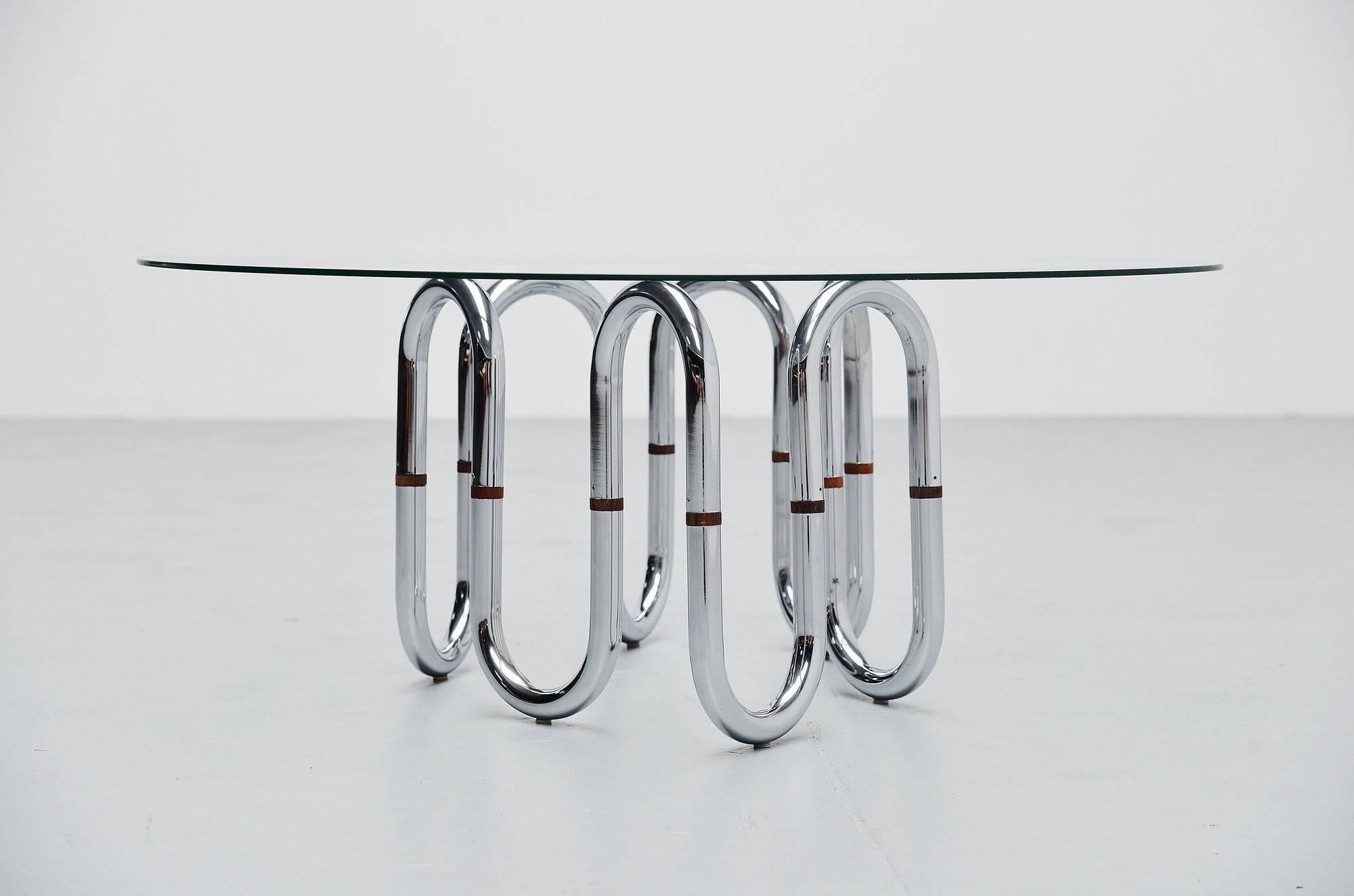 Unusual shaped coffee table with adjustable frame in tubular chrome, Italy, 1970. This table has a chrome-plated tubular metal frame with teak wooden connection parts. The frame is adjustable in many different shapes, its a very nice piece and you