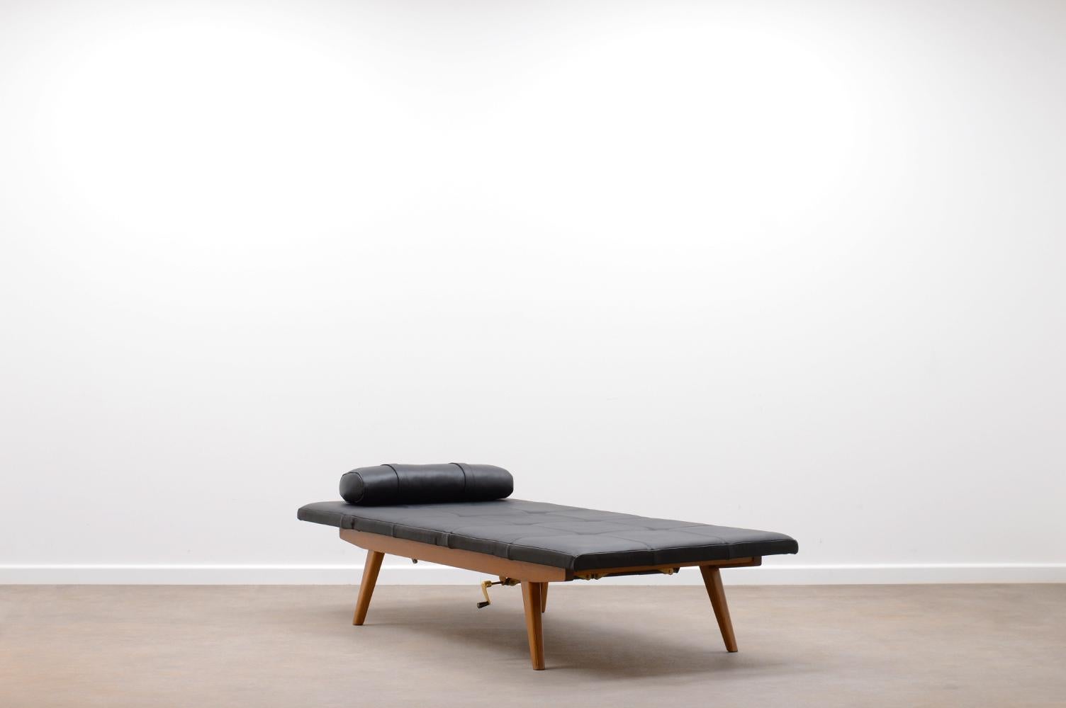 Adjustable daybed by Adolf Wrenger for Lemgo, Germany 50s. Wooden frame in classic 50s design. Reupholstered black leather cushion and fixed mattres in patchwork. Head and feet are separately adjustable. In very good vintage conditions. 

