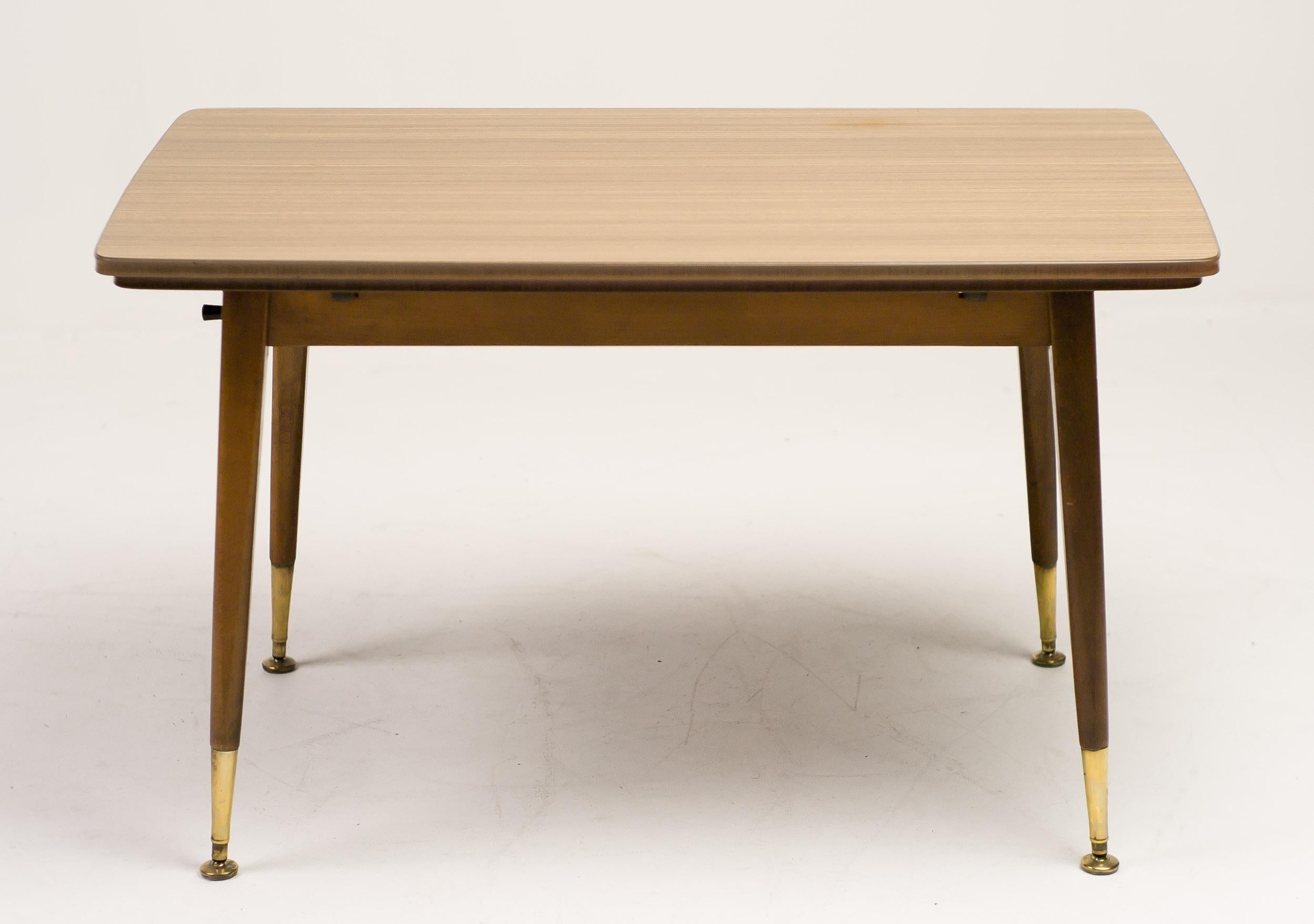 Remarkable Italian side table with a built in mechanism to extend the legs to dining height, and an extendable top.
The dimensions of the collapsed table are 109 long x 64 deep x 62 cm high.
The dimensions of the extended table are 109 long x 106