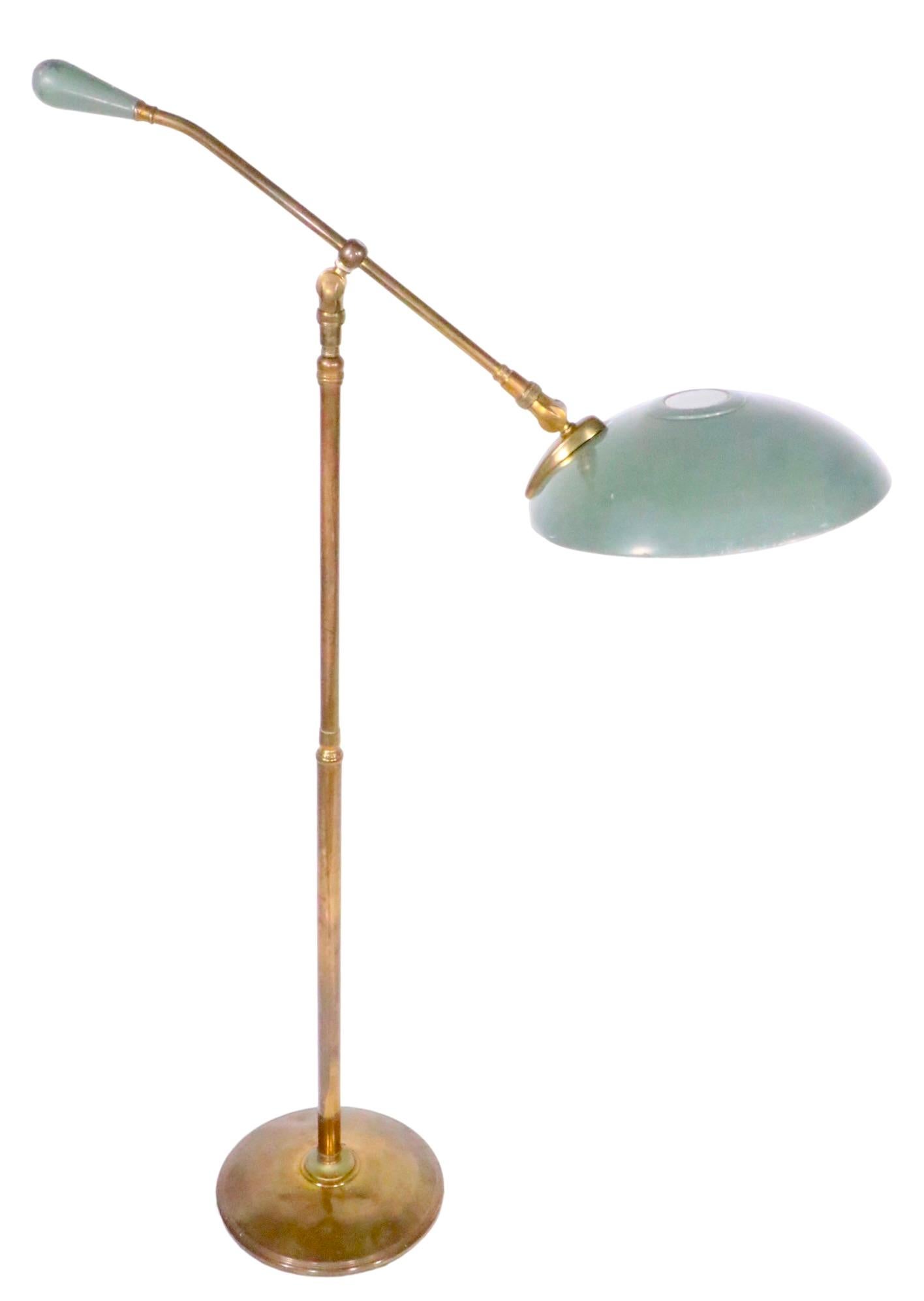 Classic Mid Century disk shade floor lamp, designed by Gerald Thurston for Lightolier. The lamp is adjustable in height ( 53 - 42.5 ) and the disk shade pivots and tilts to direct the light. This example is in good, original, clean and working