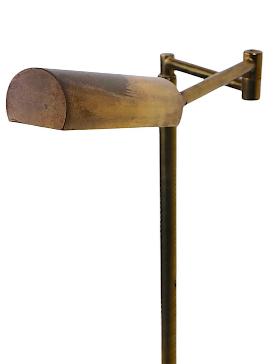 Classic vintage pharmacy style adjustable floor lamp, possibly Kotch & Lowy, Casella, etc, unsigned. The lamp features an extendable vertical pole,  horizontal flex arm, and tilting hood shade. This example is in good, original, clean, fully