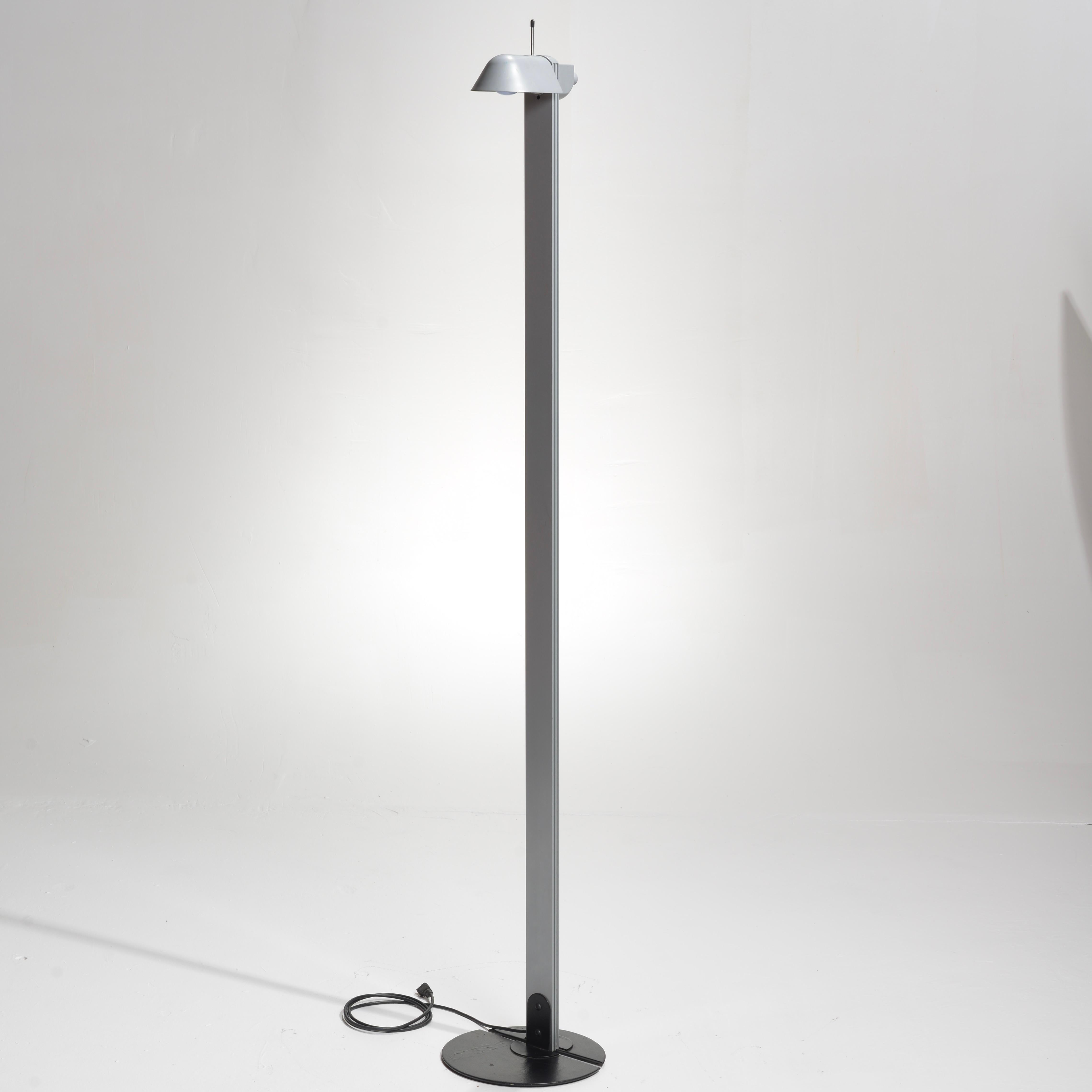 Rare Ron Rezek floor lamp with an adjustable head that swivels 360 degrees enabling it to function as a torchiere, downward facing light, or as a spotlight. It has a dimmer switch on the top for low or bright light. It has a round base with space