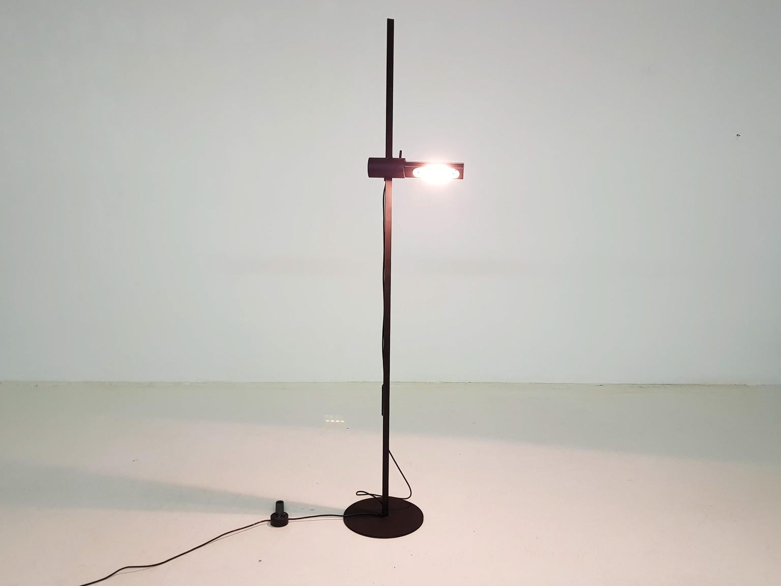 Black floor lamp with an adjustable metal shade and lamp, which glides around a metal pole.

The floor light is in good working condition with traces of use to the black metal paint. Lamp has a dimmer floor switch. Lamp is from 1982 and marked by