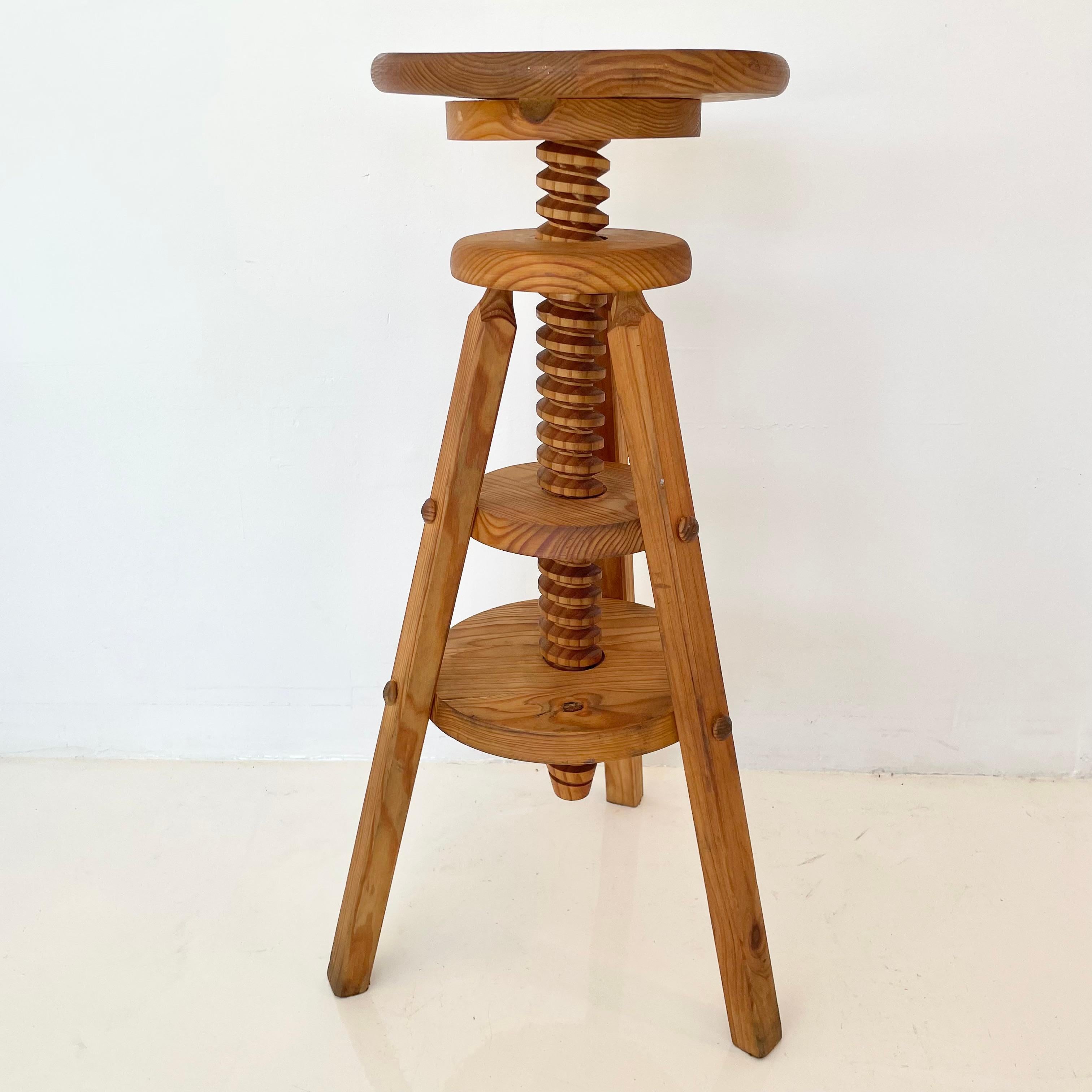 Sculptural stool made entirely of wood. Large wood screw penetrates the three tiers of the stool allowing the height to be adjustable with a quick spin. Great for the piano, showcasing art or a standalone seat. Good vintage condition. Measures: