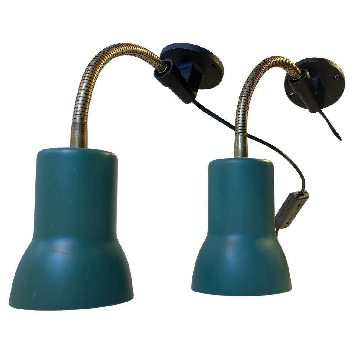 A pair of fully adjustable brass wall lights with teal green aluminum shades and black acrylic wall mounts. Manufactured by Lyskær in Denmark circa 1970. Measurements: H/L: 34.5 cm, Diameter: 9.5 cm (shade).