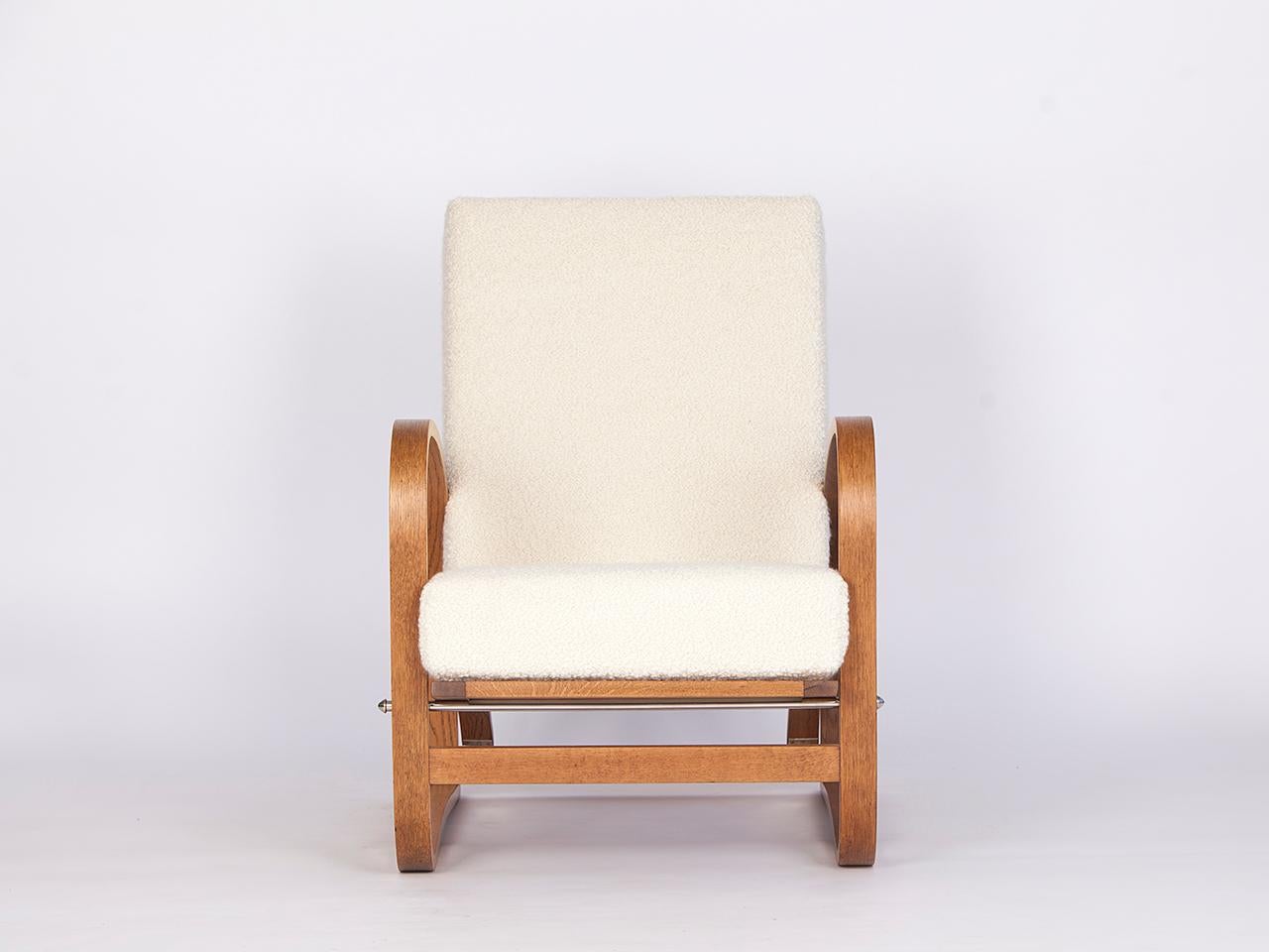 This H-70 armchair was designed by Jindrich Halabala and produced by Spojene UP zavody, circa 1930. The backrest and seat can be put in three different positions. The wooden parts restored. Covered with an Italian fabric made of soft wool and alpaca