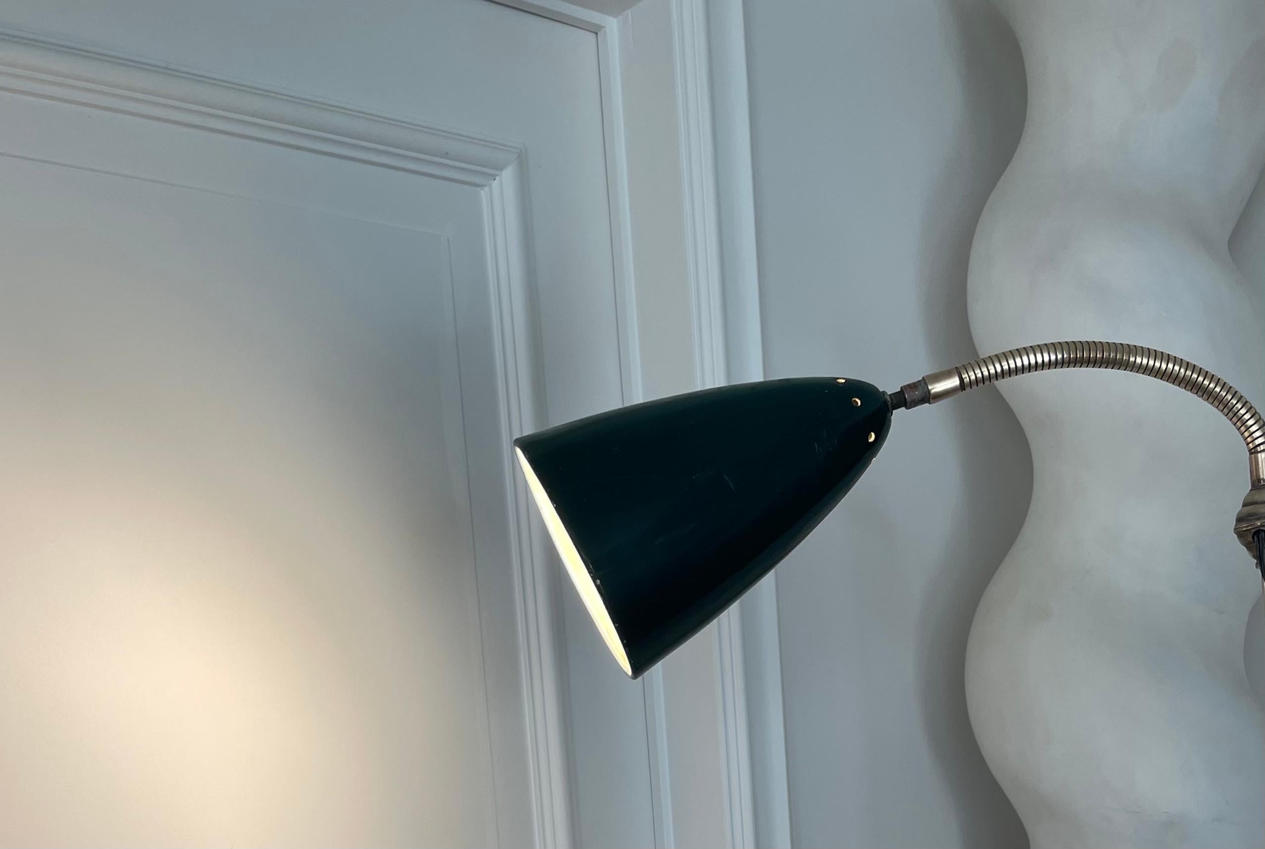 Mid-20th Century Adjustable Industrial Floor Lamp With A Green Reflector, France 1950. For Sale