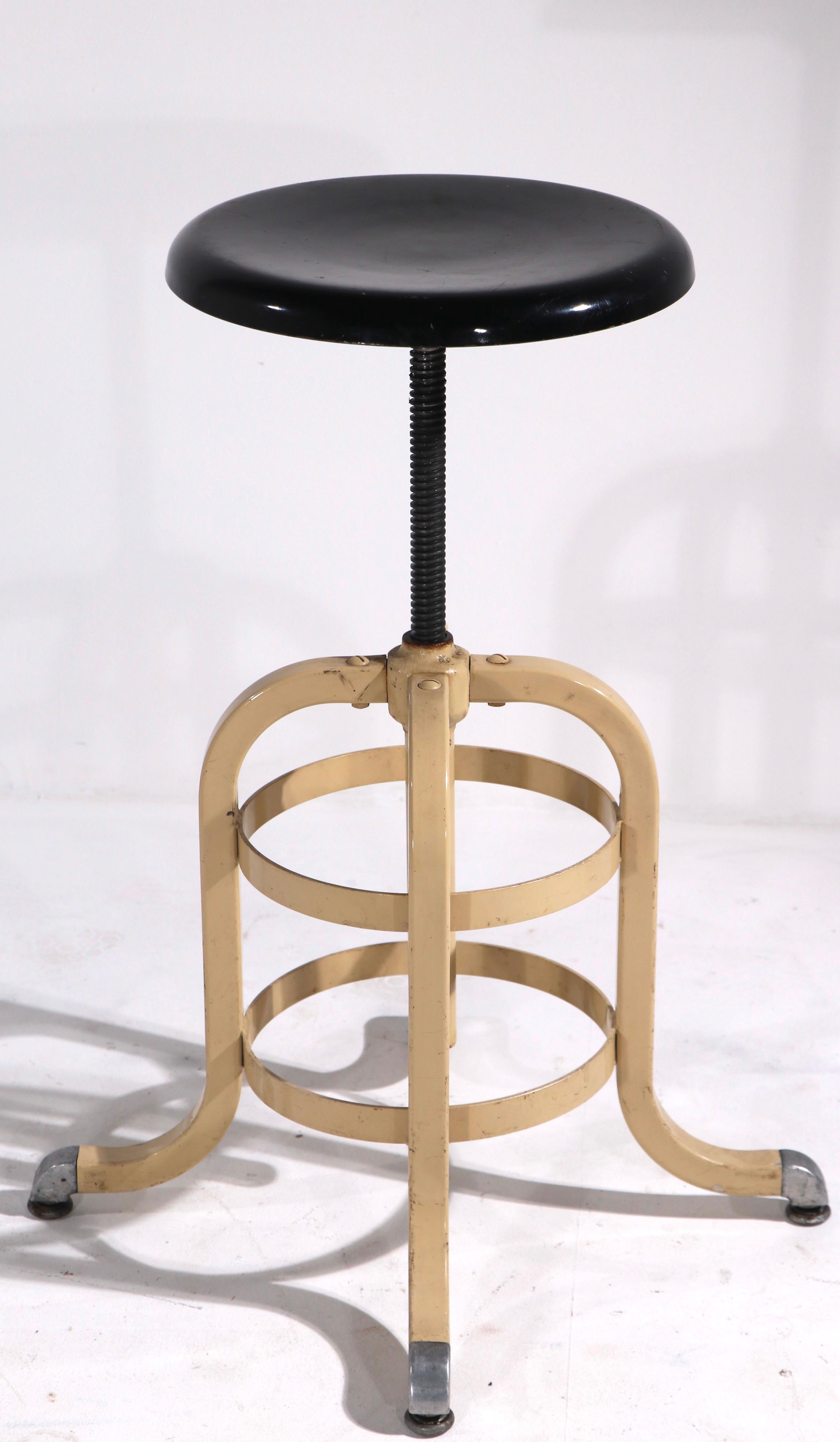 Nice industrial stool having a swivel top, with stationary base. Adjustable in height ( 26.5 - 18.5 ) Dia. of seat 12 inch. Exceptional original condition - Marked by maker A.S. Aloe.