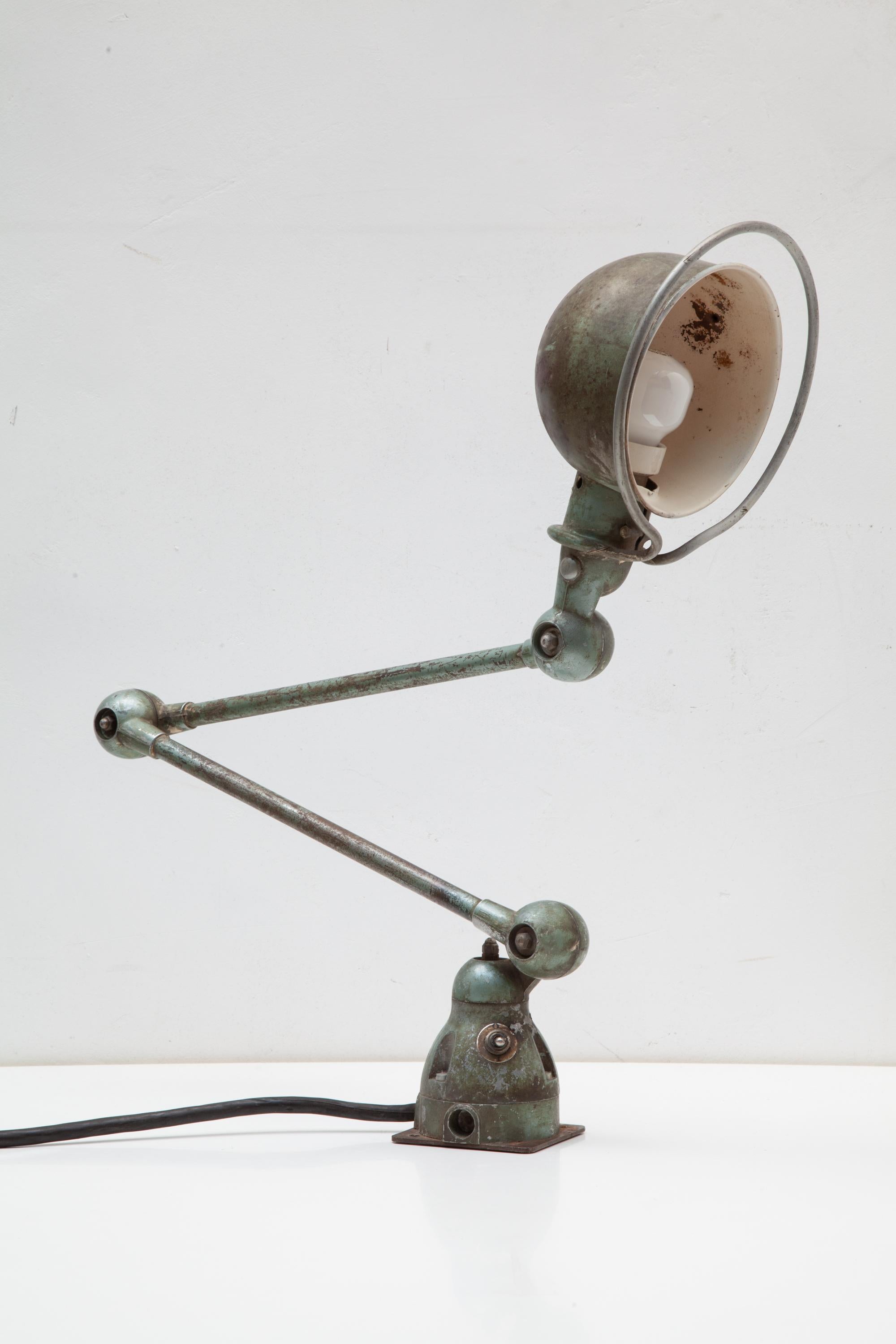 Jieldé is a French brand of industrial lamps made in 1950 by Jean-Louis Domecq (1920-1983).Jean-Louis Domecq started with the design of a special adjustable lamp.
This two-arms lamp with a nice vintage patina allows for many articulations also can
