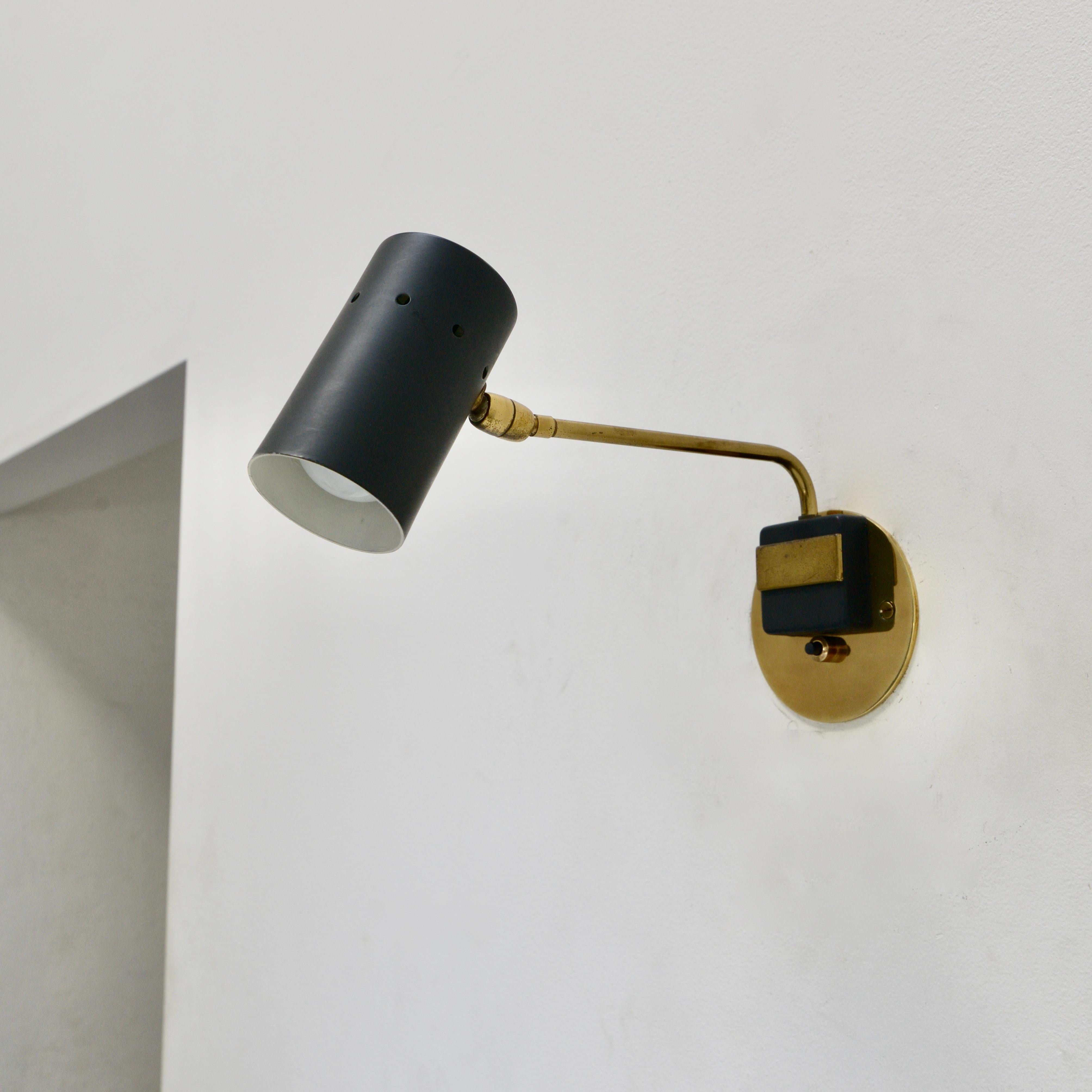 Single naturally aged brass and painted aluminum adjustable Italian Spot Sconce from 1950s Italy. Arm swings from side to side. Wired with 1 E12 candelabra based socket for use in the USA. Can can also be wired for use anywhere in the world.