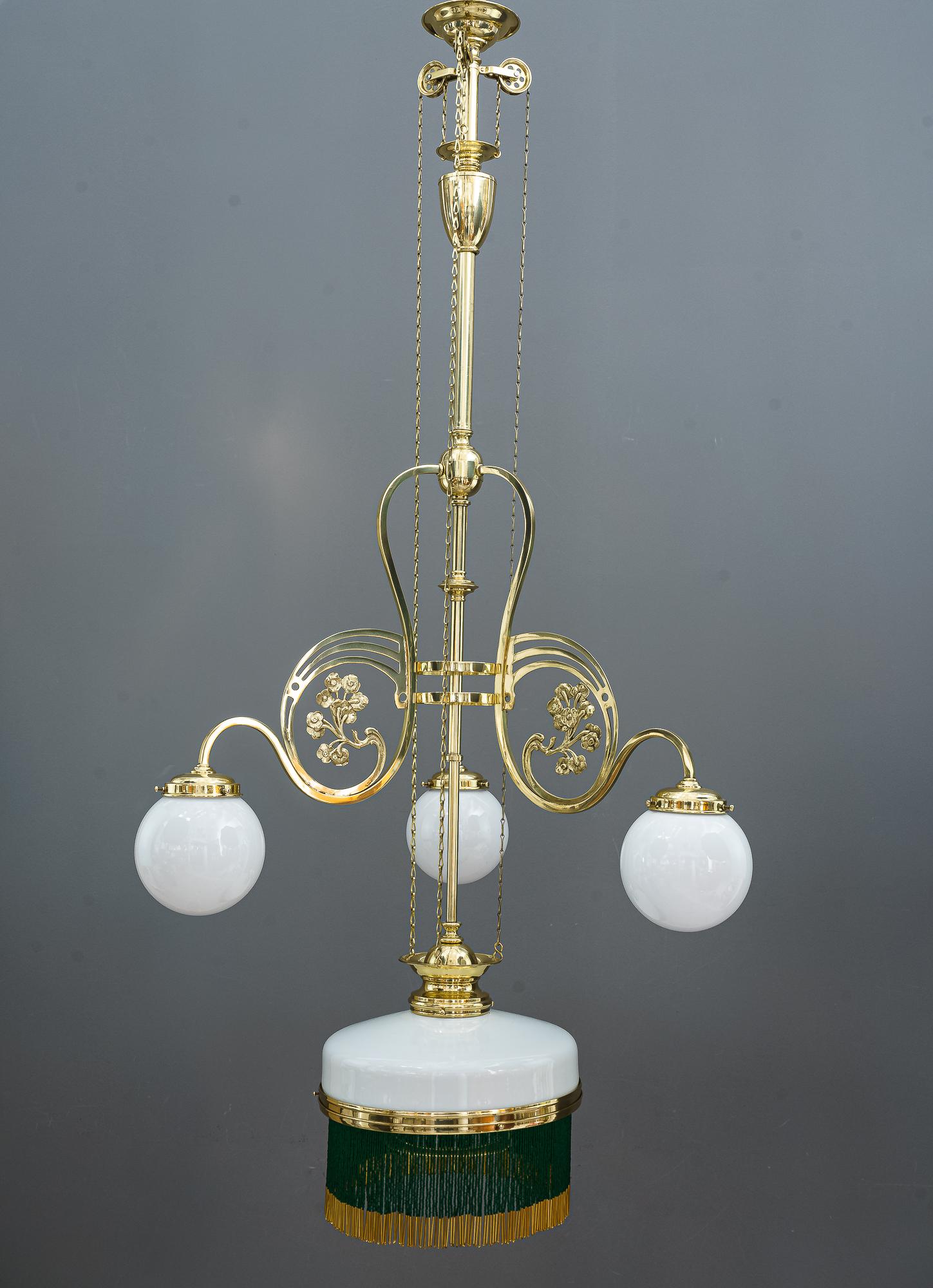 Adjustable Jugendstil chandelier with original opal glasses, Vienna, circa 1908
The pearls are new
Polished and stove enameled
Adjustable from 122cm up to 141cm.