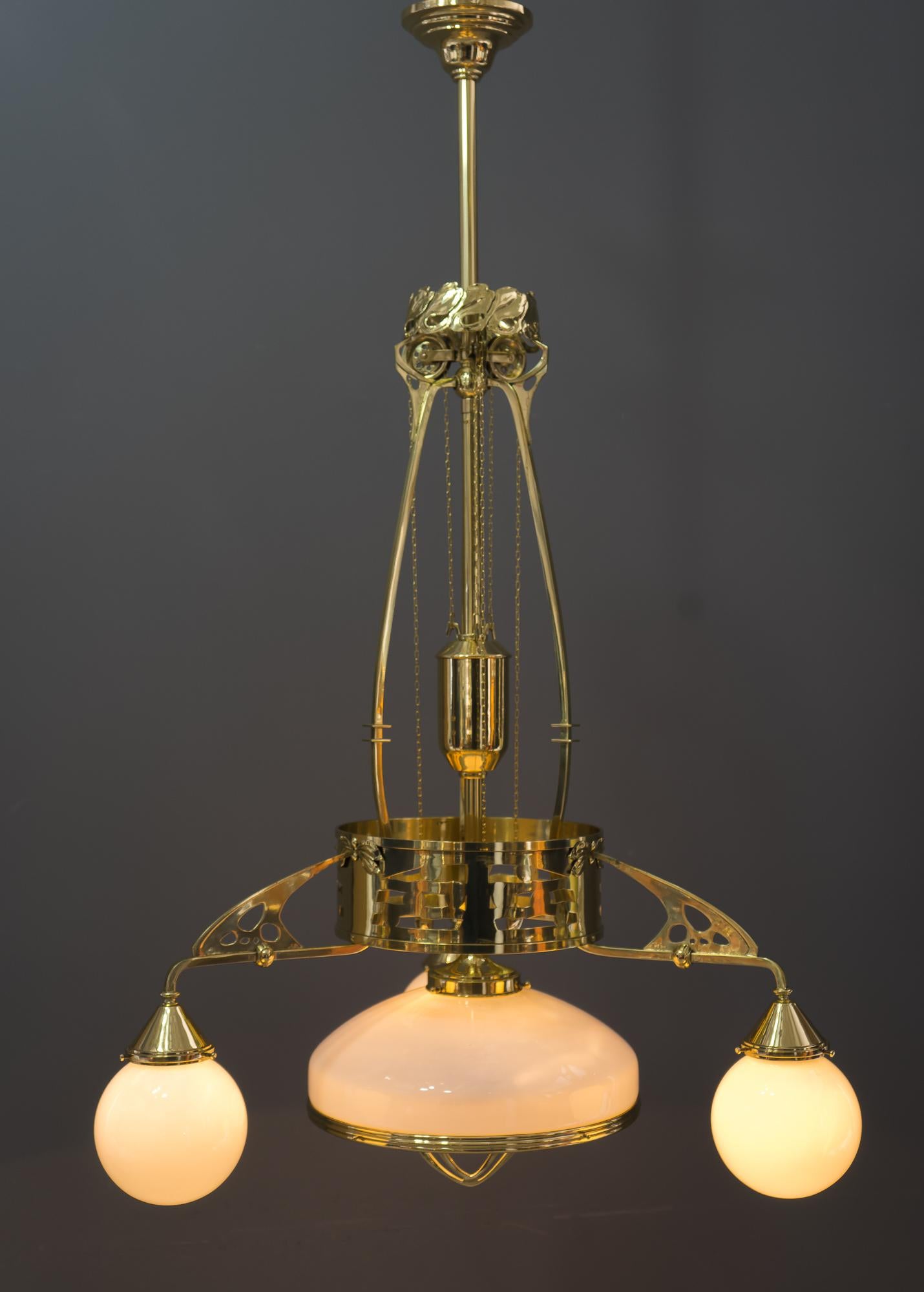 Adjustable Jugendstil chandelier with original opal glasses, Vienna, circa 1910s
Polished and stove enameled
Original opal glasses
Adjustable vrom 125cm-150cm.