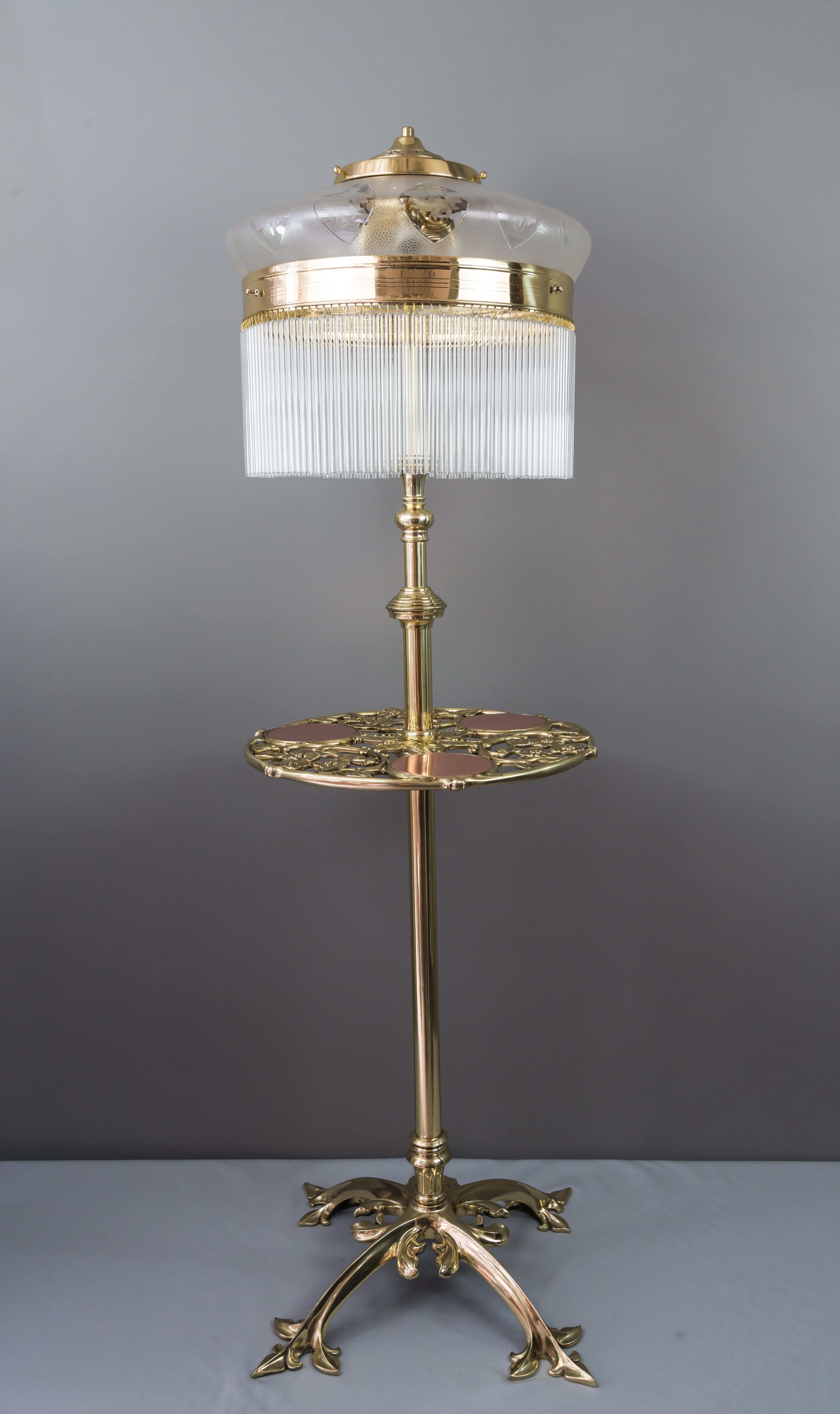 Adjustable Jugendstil floor lamp with original antique glass shade and 3 copper glass holding plates circa 1908.
Polished and stove enameled brass and copper.
High is extendable from 130cm - 180cm.