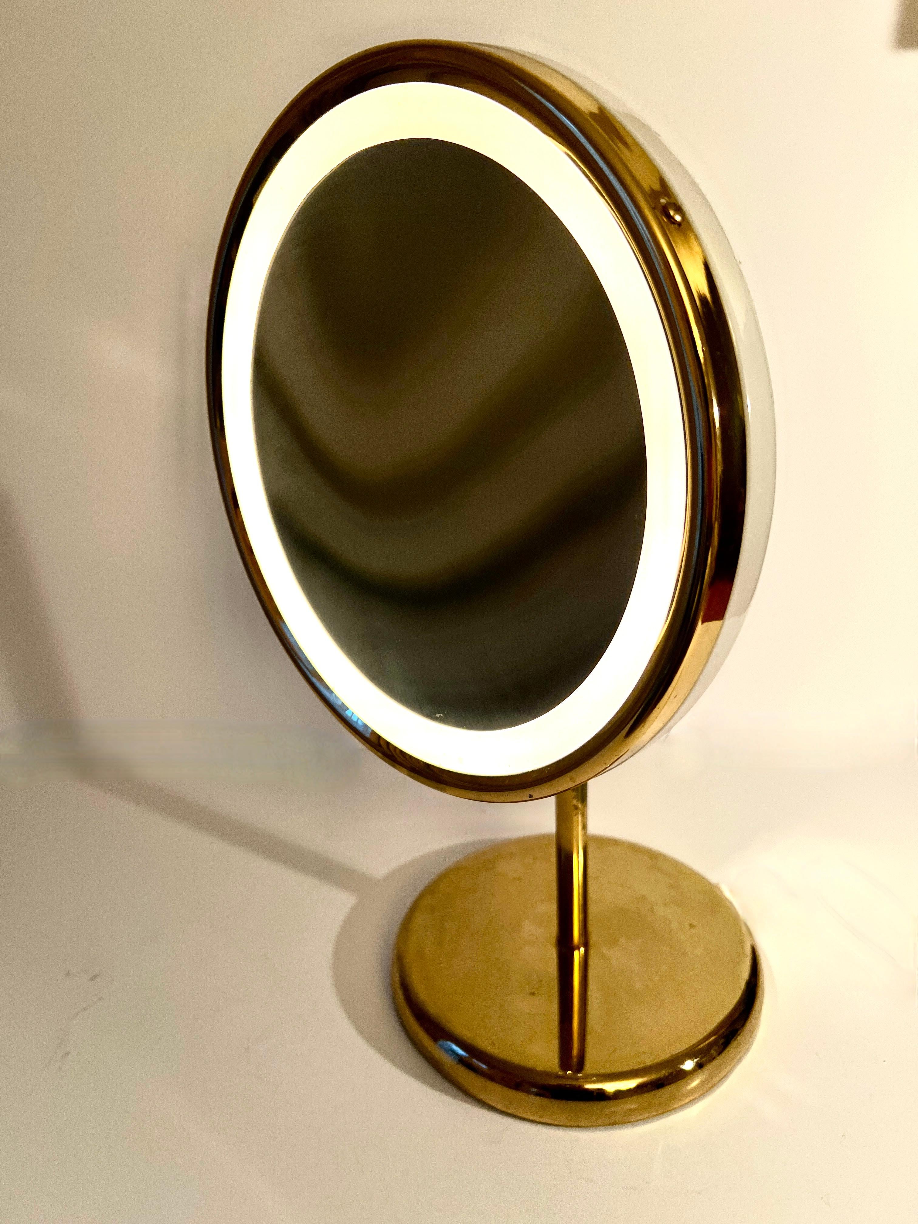 Patinated Adjustable Magnifying Ring Lit Table Mirror on Brass Stand with Brass Details For Sale