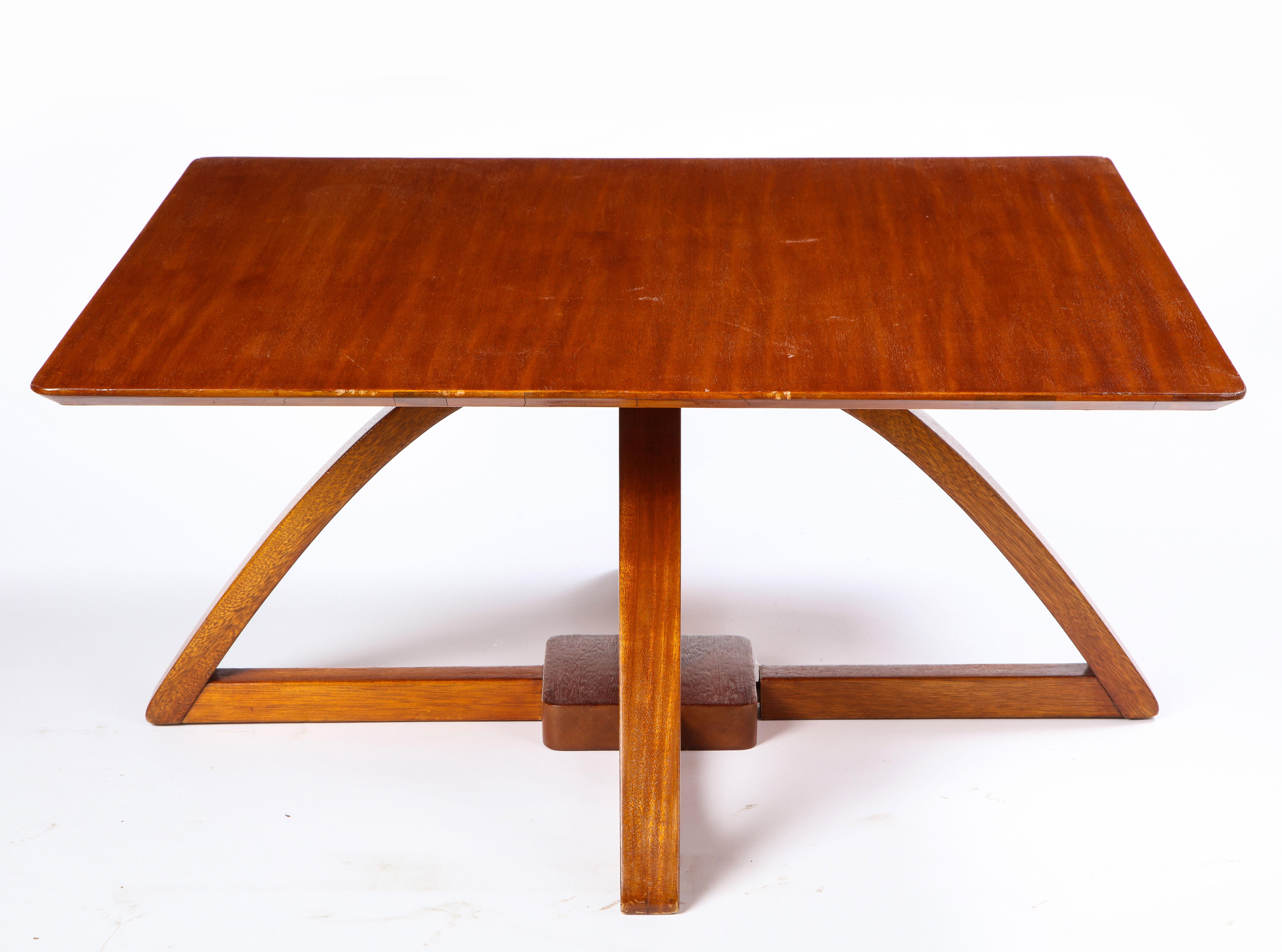 A modern mahogany low table, with adjustable height. Its square form and large legs make it a stable piece, which can be used as a low dining table but most typically a lowboy table. This table was custom made in South Africa. With its clean look,