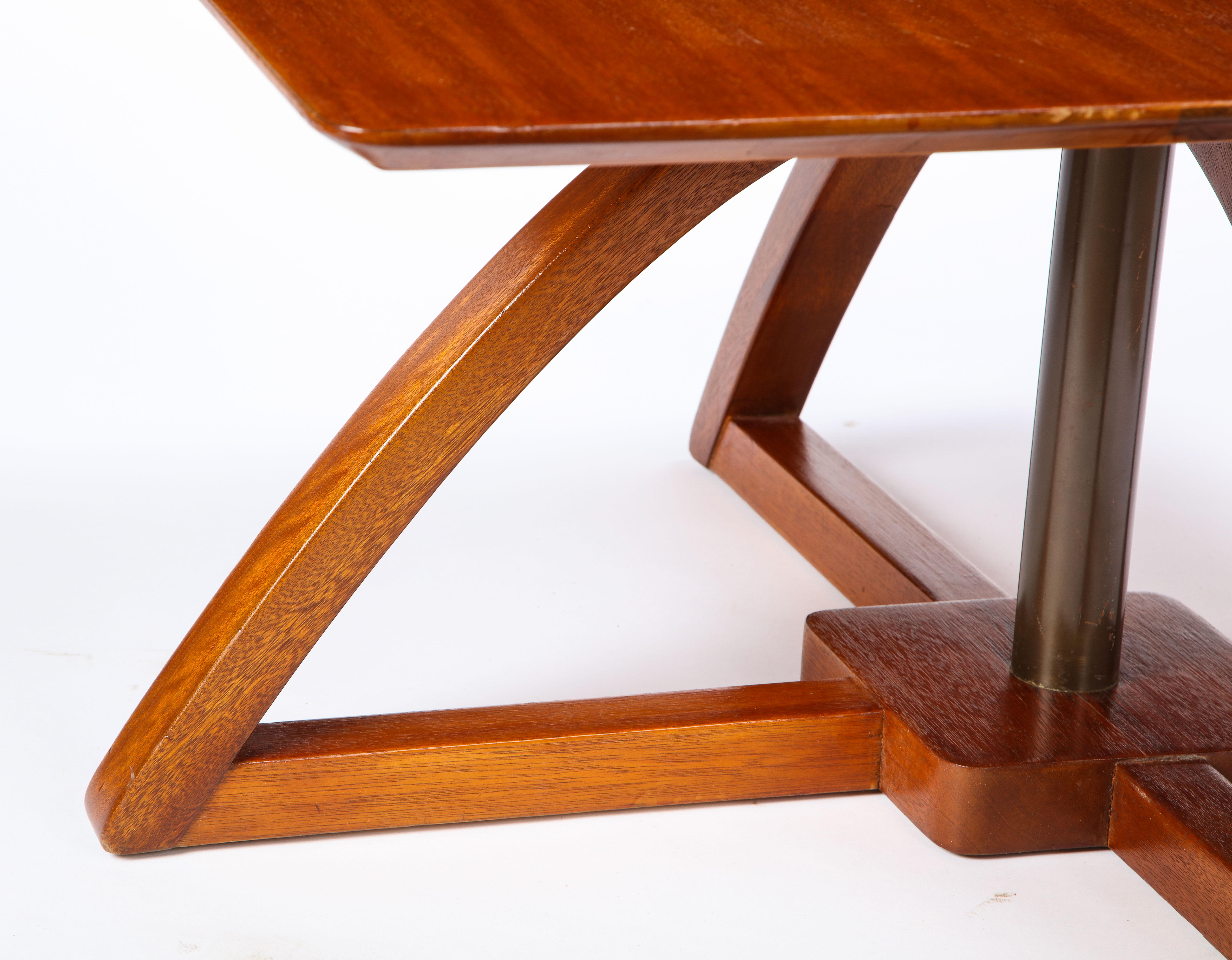A modern mahogany low table with the ability to be adjustable in height. Its square form and large legs make it a stabile piece, which can be used as a low dining table but most typically a lowboy table. This table was custom made in South Africa.