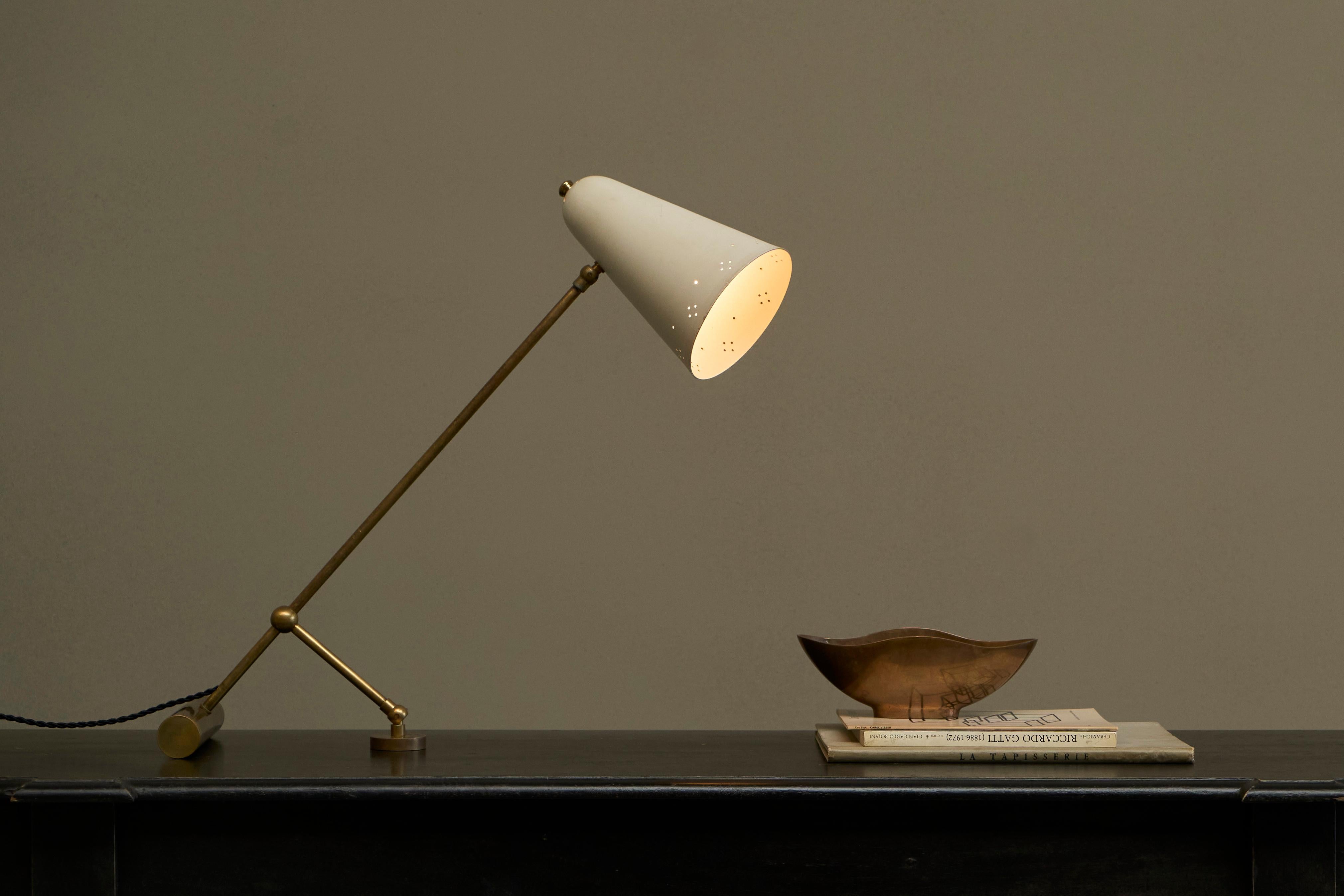 Adjustable Mid Century Table Lamp with Perforated Shade 1950s.

A wonderful and very elegant 1950s table lamp with a nice perforated white lacquered shade. Fully adjustable, can be positioned any way you like - straight up or more stretched out and