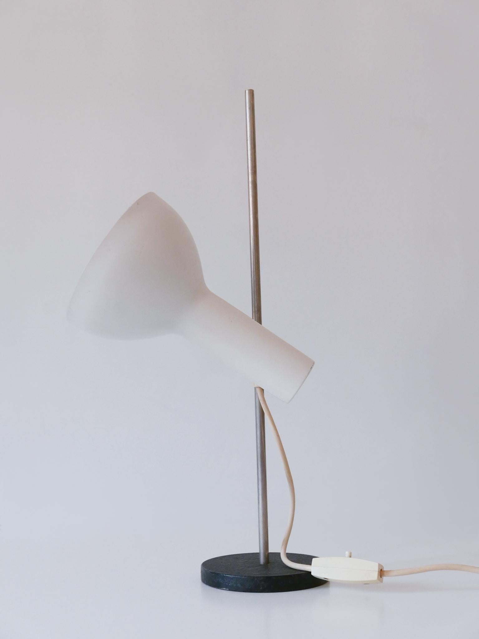 Rare & Minimalistic Mid Century Modern desk light or table lamp. Adjustable height and lamp shade. Designed and manufactured probably by Gebrüder Cosack, Germany, 1960s.

Executed in beige / white colored aluminum, nickel-plated metal rod and in