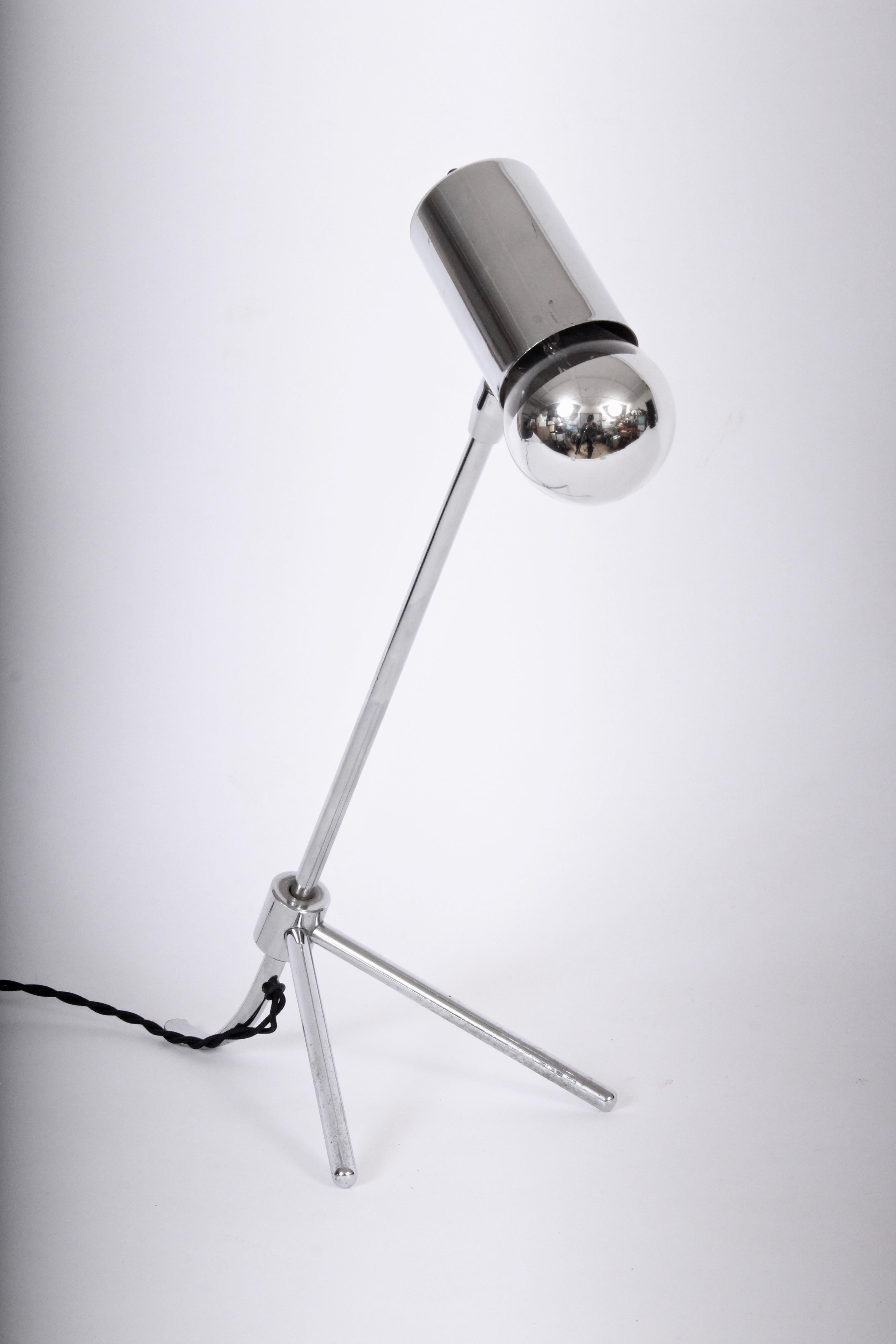Modernist nickel-plate tripod petite table lamp, in the manner of Jean Boris Lacroix, 1960's. Adjustable positions, standard size socket, featuring a round Mercury glass bulb. Premium quality. Finely crafted. Minimalist design.