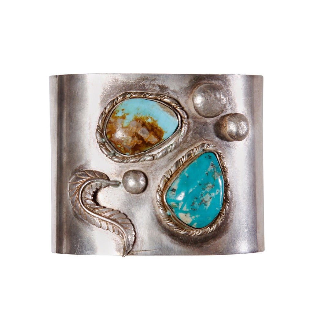 Gorgeous hand-made vintage sterling silver cuff with two large turquoise stones. This is a Native American artisan piece and was engraved, 