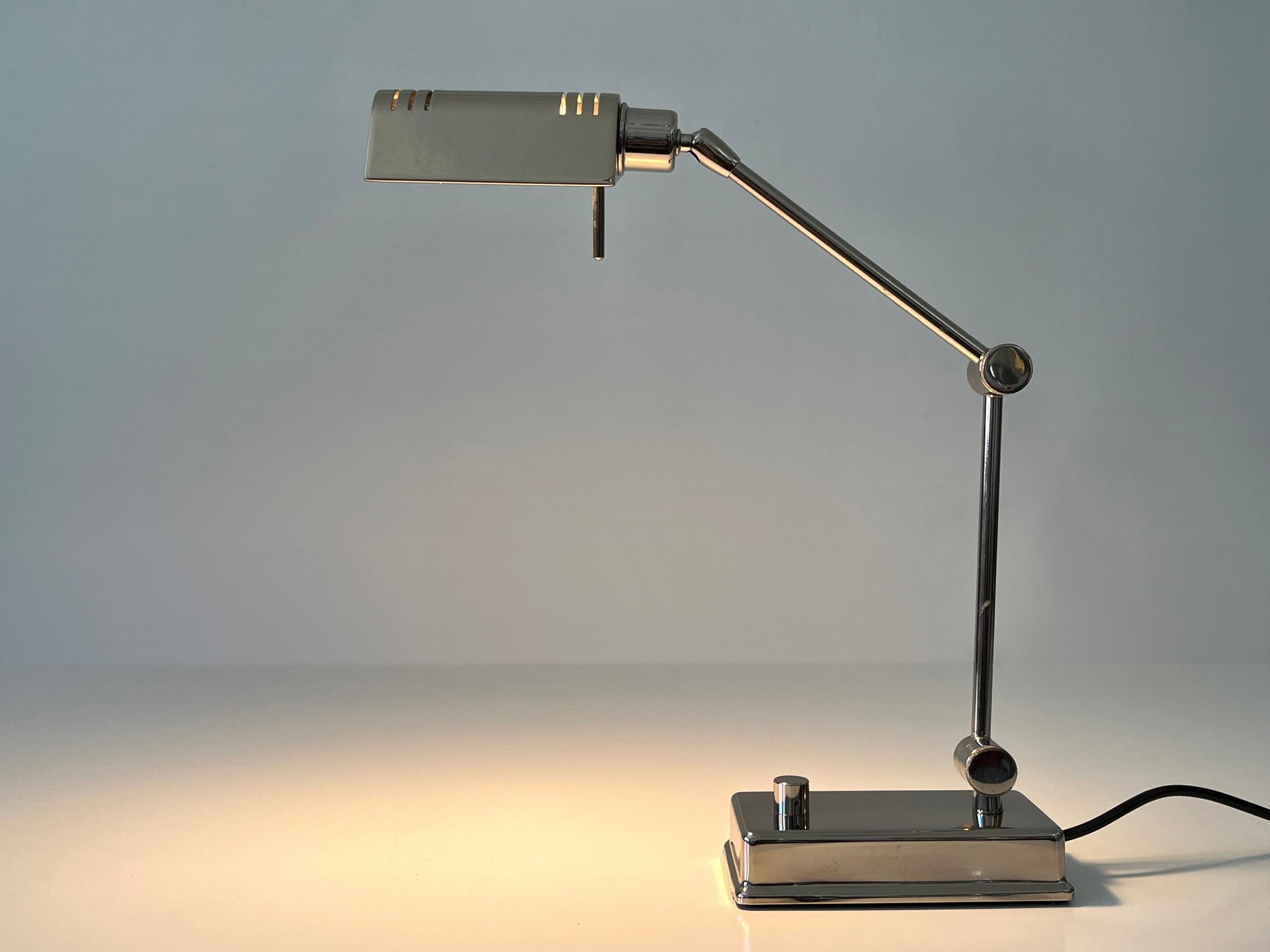 Elegant and adjustable vintage brass desk light. With adjustable arm and rotating lamp shade.
Designed and manufactured by Holtkötter, Germany, 1980s.

Executed in nickel-plated brass, the desk light needs 1 x halogen bulb, max. 100 Watt. Dimmable.